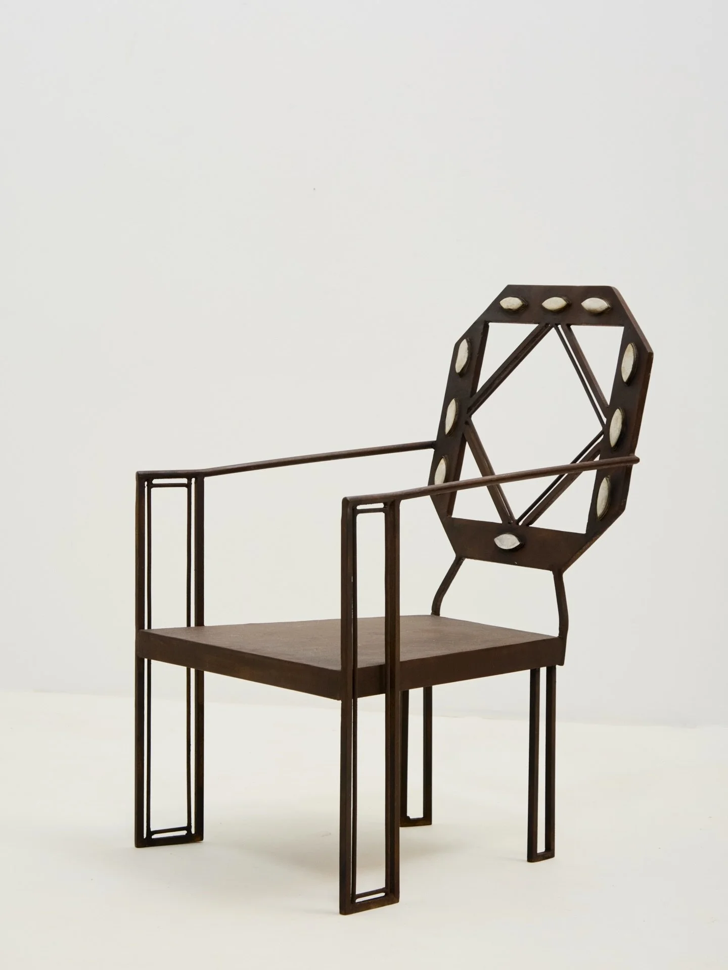 Outlandish wrought iron accent chair, made by a clearly gifted artist / metalworker. 

Excellent symmetry throughout, from the bejewelled back rest to the framed detail on the front legs.

Origin unknown, found in Paris. 

Circa 1915.

H 77cm x W 47c