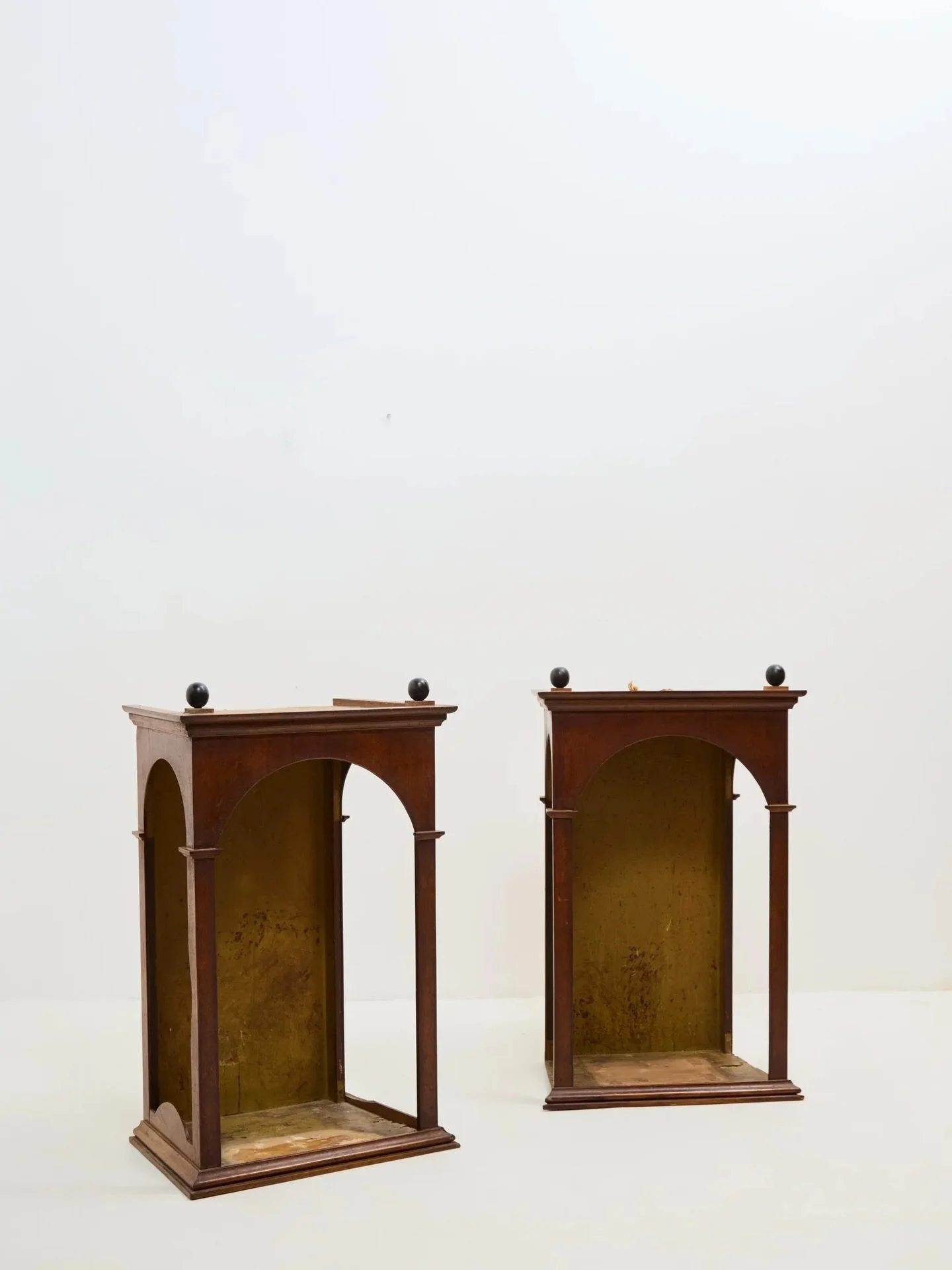 Head turning turn of the century alcove cabinets.. somewhere to house those curio collections perhaps?

Would have previously been wall hung or mounted on pedestals. 

Unusual exaggerated arched openings on three sides, excellent turned ball finials 