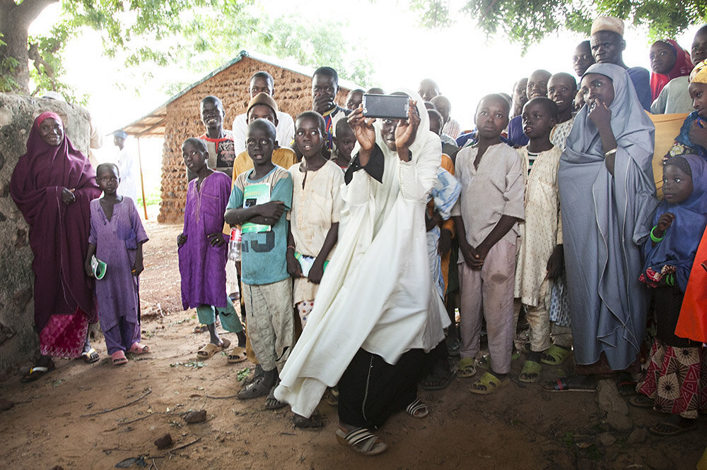 Hassana Abubakar, a facilitator for literacy classes, takes pictures in Rudu Gidan Dikko, Sokoto, Nigeria. © Laura Elizabeth Pohl