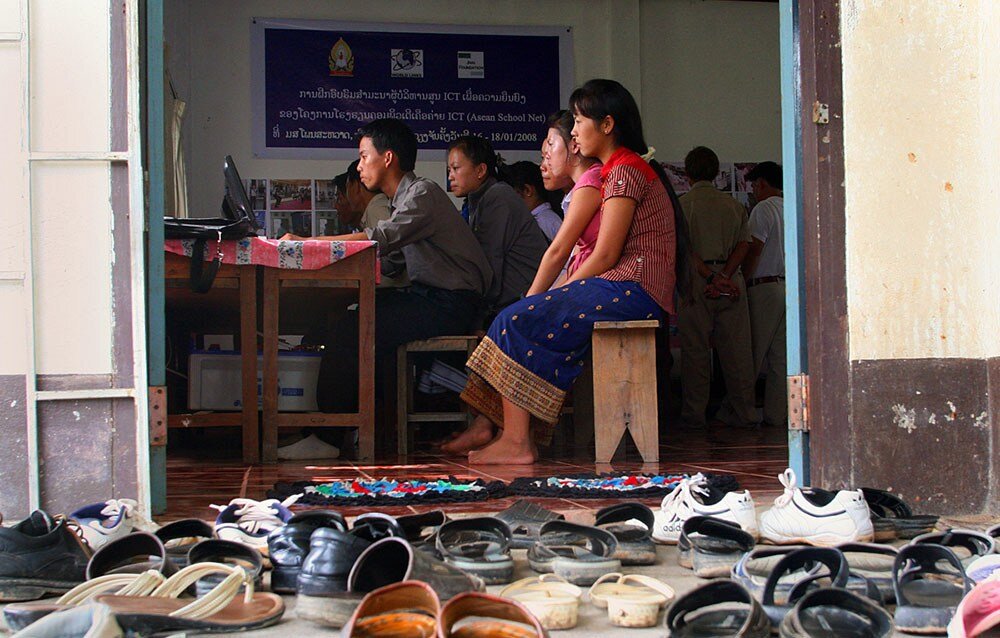 Photo caption: Students at Phonsavad Secondary School in Phonsavad, Laos, flocked to the school during vacation for a chance to use one of the school's 11 computers. Some students waited as long as one hour for their turn to practice typing or get o…