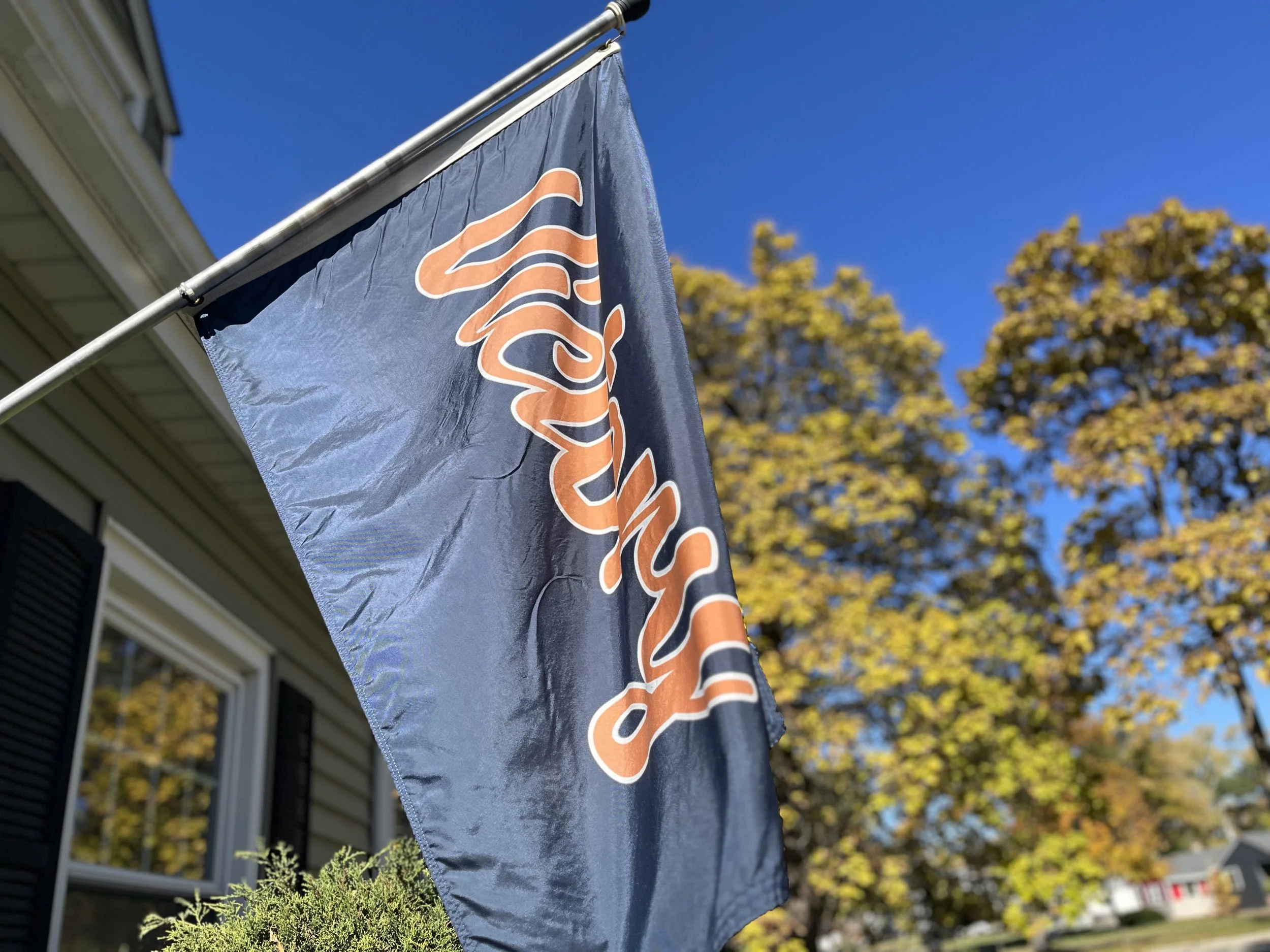 Premium Navy Bears Flag [hanging in a home gym / on a suburban flagpole] to honor the bearswin.