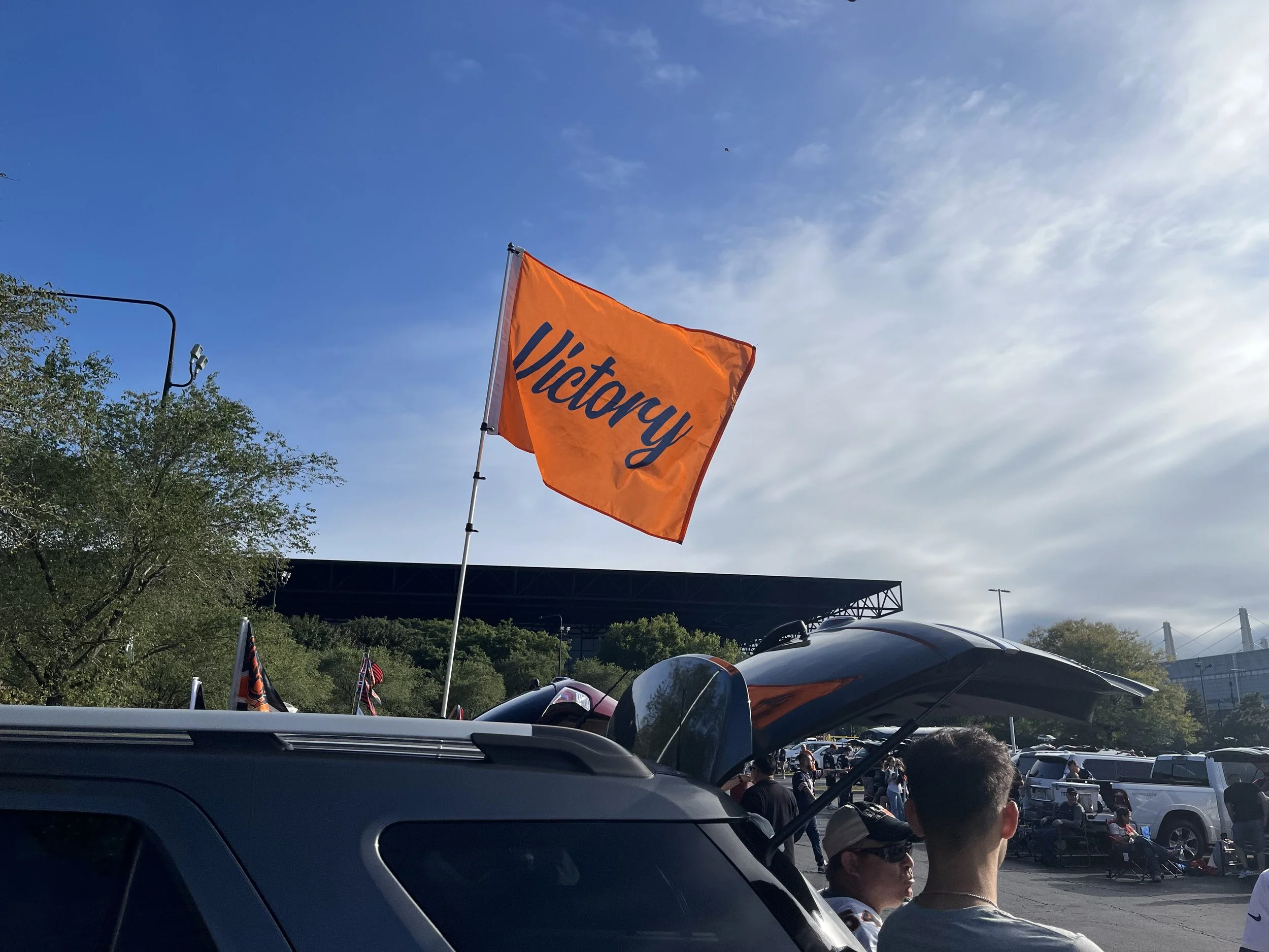 Bright Orange Bears Flag [waving in the wind / at Soldier Field] featuring navy blue Victory script.