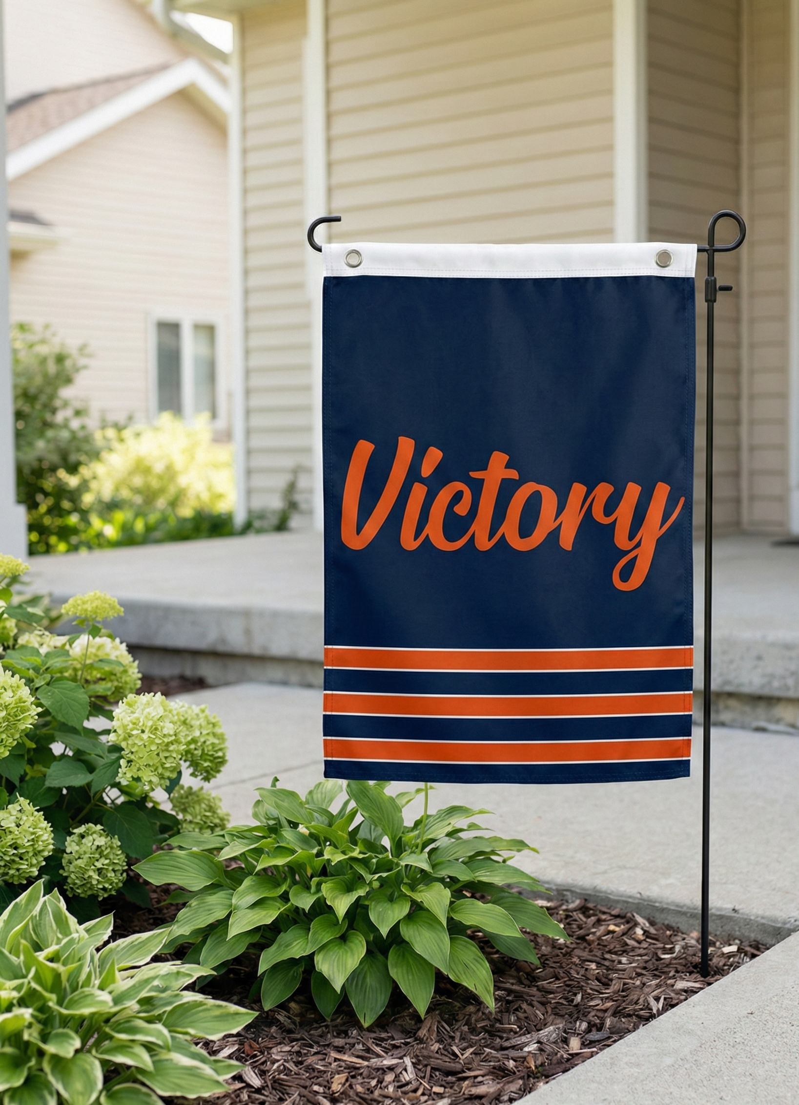 Navy Garden Size Victory Flag [standing in a flower bed / near a front walkway] for a subtle gameday signal.