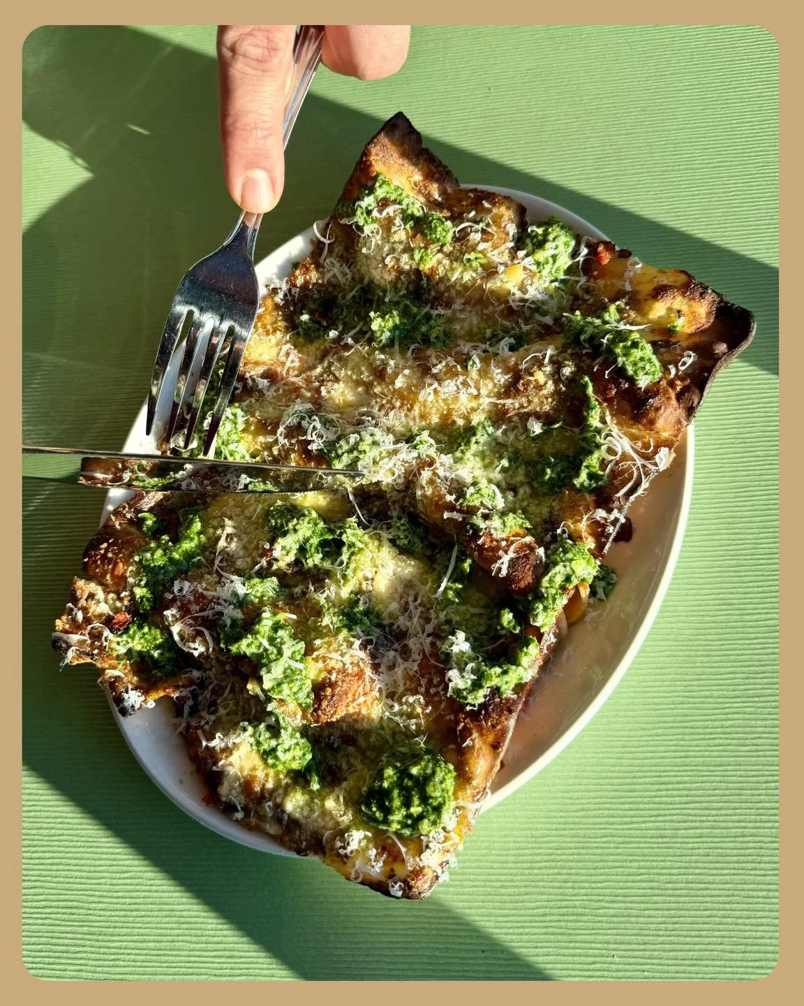 An overflowing plate of roasted mushroom, creamy ricotta, and tomato lasagna, topped with basil arugula pesto and complete with crispy edges!