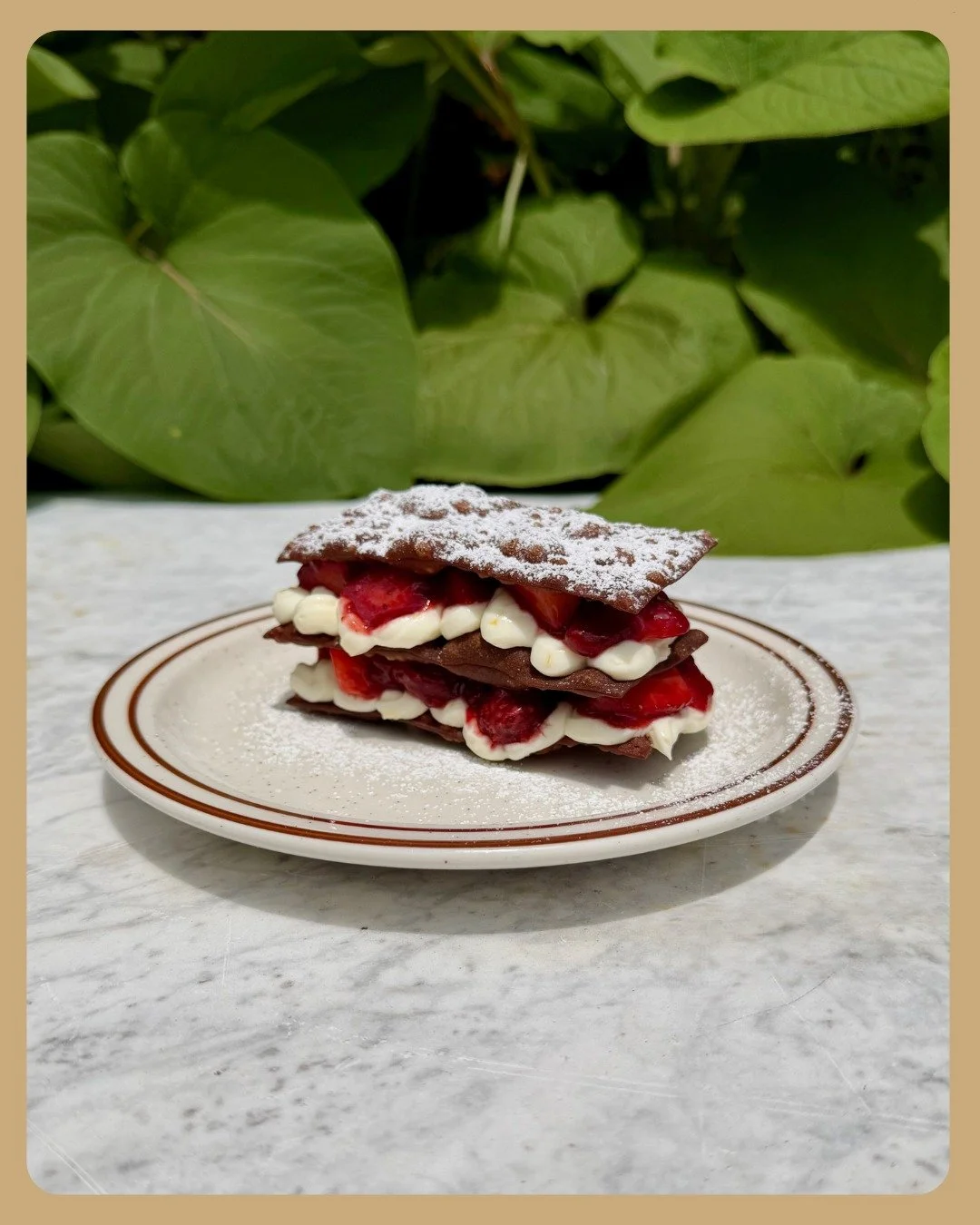 We mashed a cannoli with a napoleon to get a "cannoleon" &trade;!

Layers of fried cannoli shell, whipped ricotta scented with lemon, and fresh cut strawberries tossed in a little strawberry jam, all topped with powdered sugar 🥰!