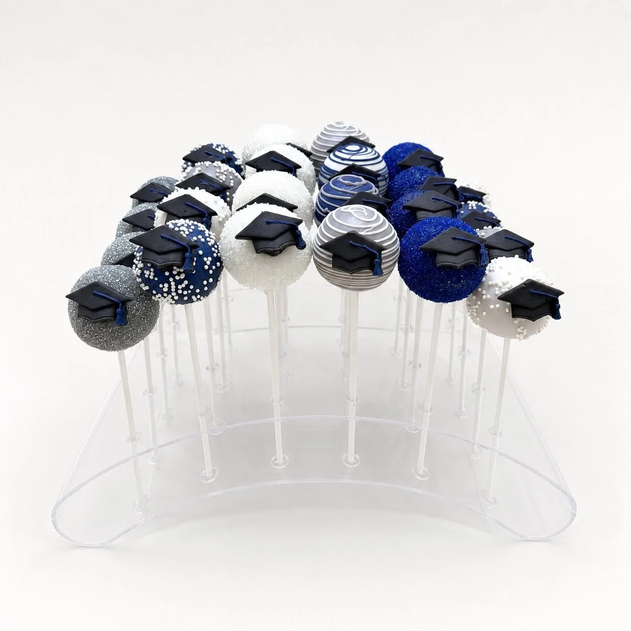 Silver, Navy, and White Graduation cake pops in stand