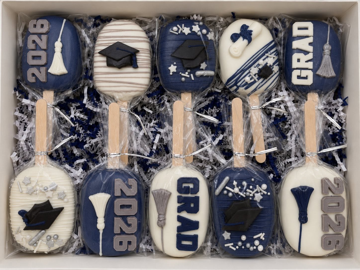 Silver, Navy, and White Graduation cakesicles in box