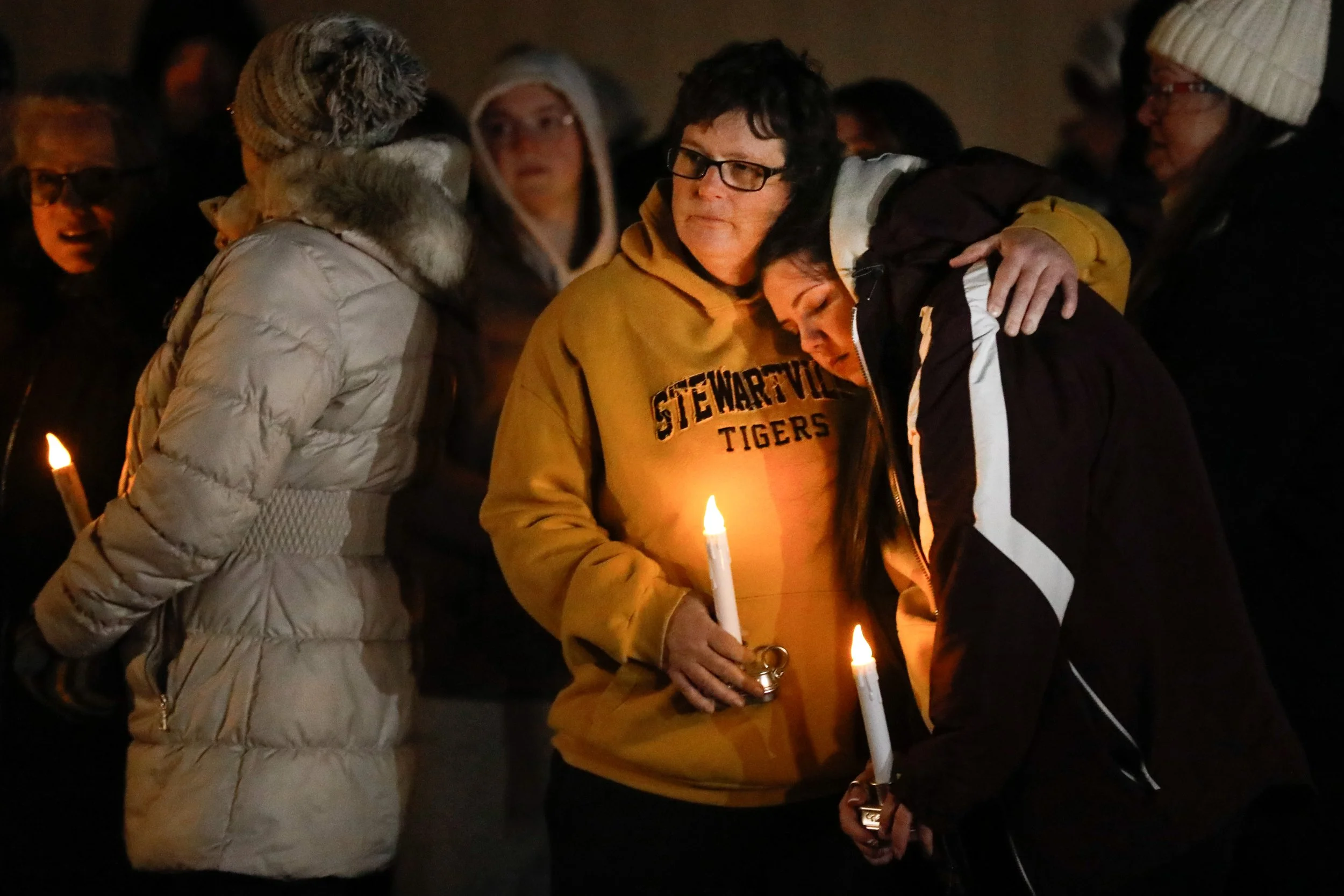 Michelle Cross embraces her daughter Samantha during a candlelight vigil and prayer for Stewartville community members affected by last Friday’s shooting on Wednesday, Dec. 17, 2025, in Stewartville.