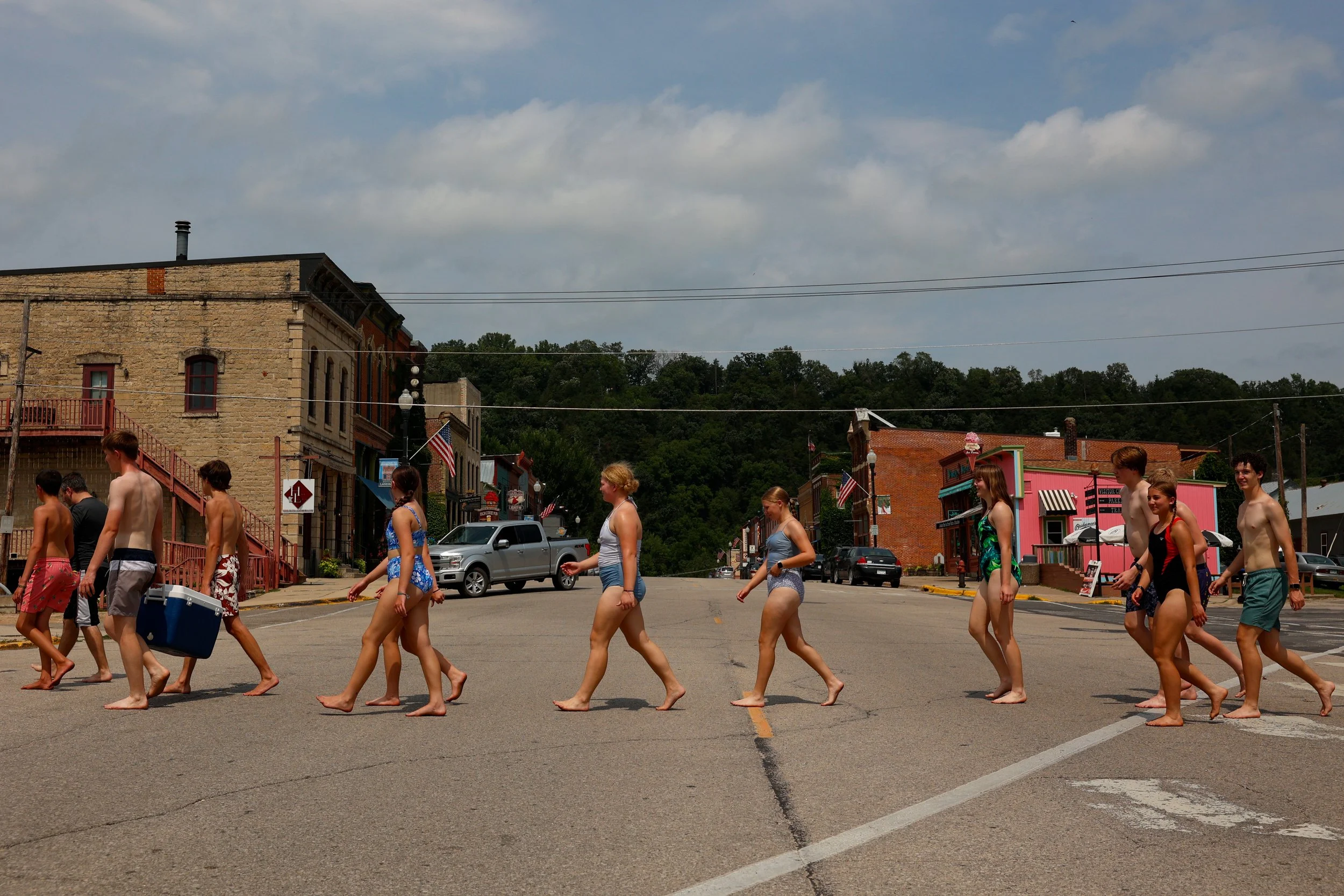 Members of church youth groups from Rochester, Le Sueur, Bloomington and Eau Claire, walk towards Root River Outfitters for river tubing on Friday, Aug. 8, 2025, in Lanesboro, Minn.