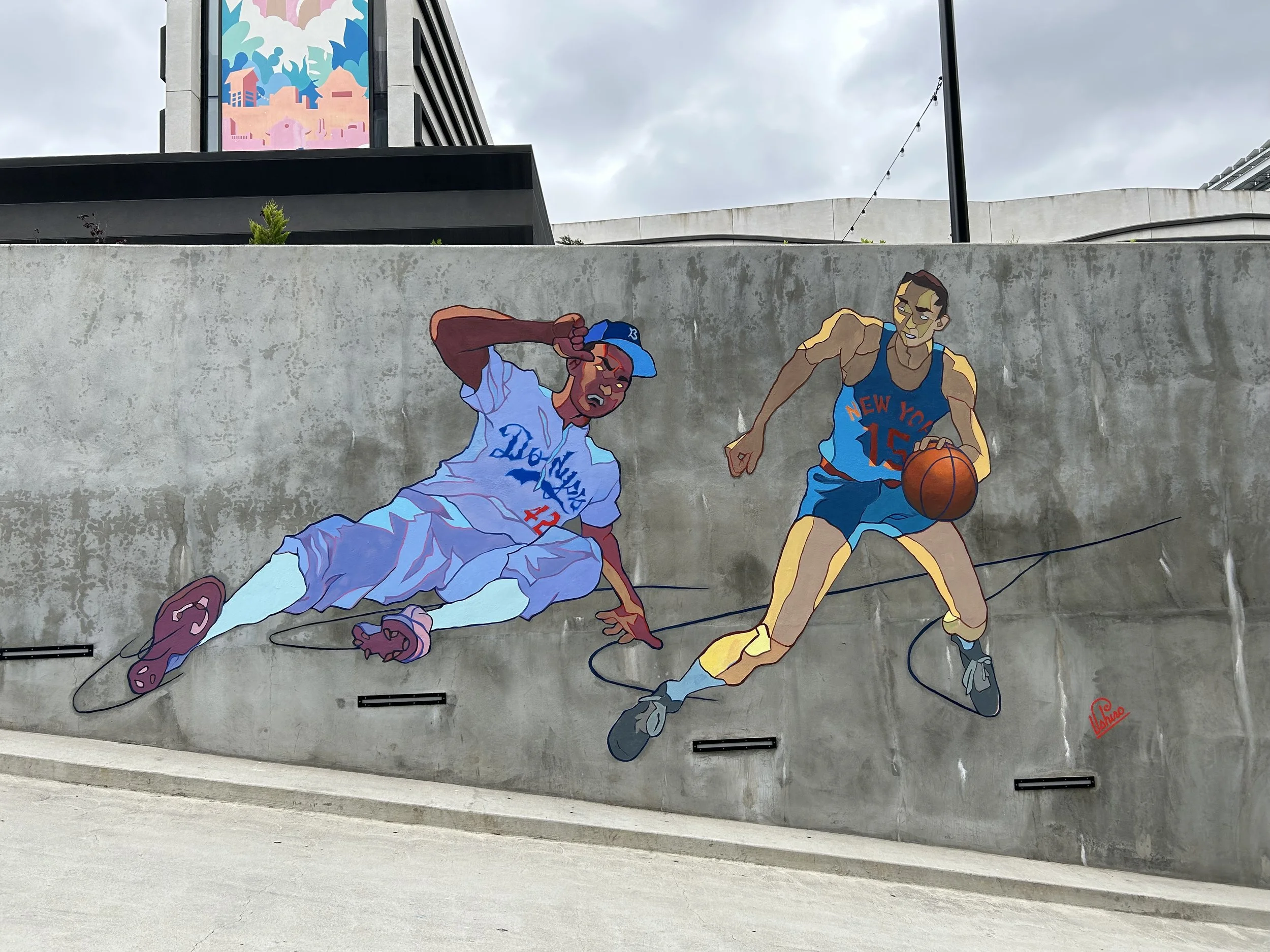Closeup of an exterior mural celebrating Jackie Robinson and Wat Misaka.
