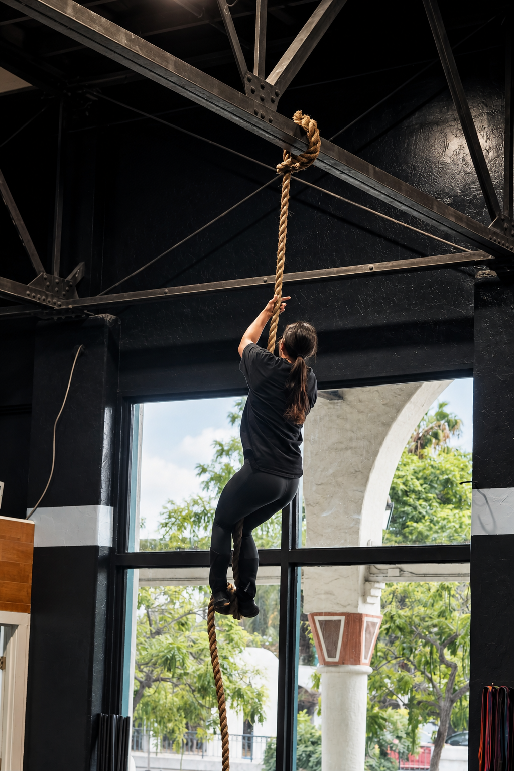 Industrial Rope Climb in Sunlit Gym.png