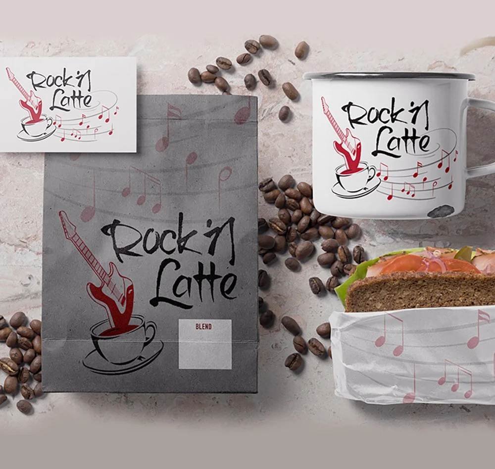 A coffee mug, a box of ground coffee, a sandwich wrap with a sandwich inside, and scattered coffee beans, all branded with "Rock'n Latte" and a guitar logo.