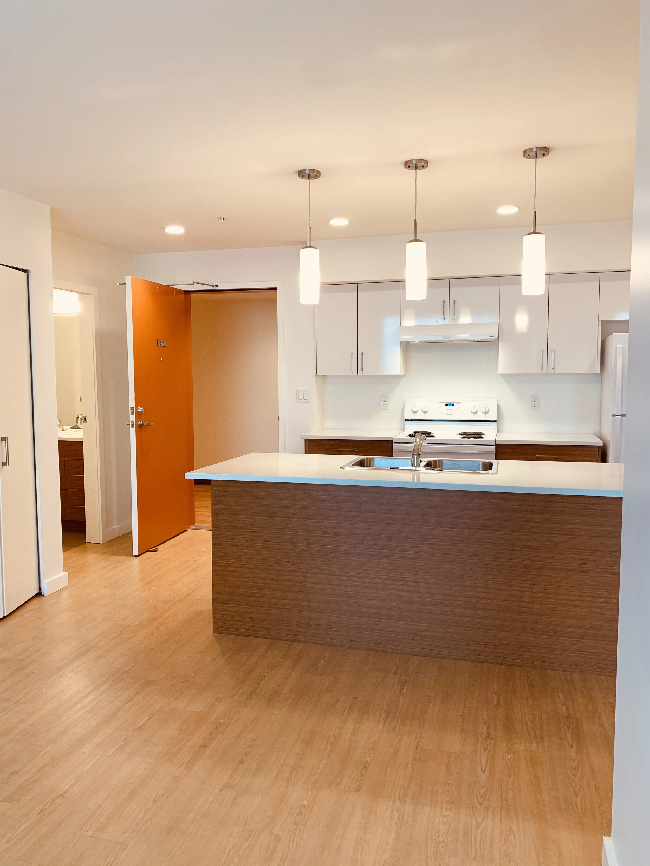 From main living area towards kitchen and entryway.