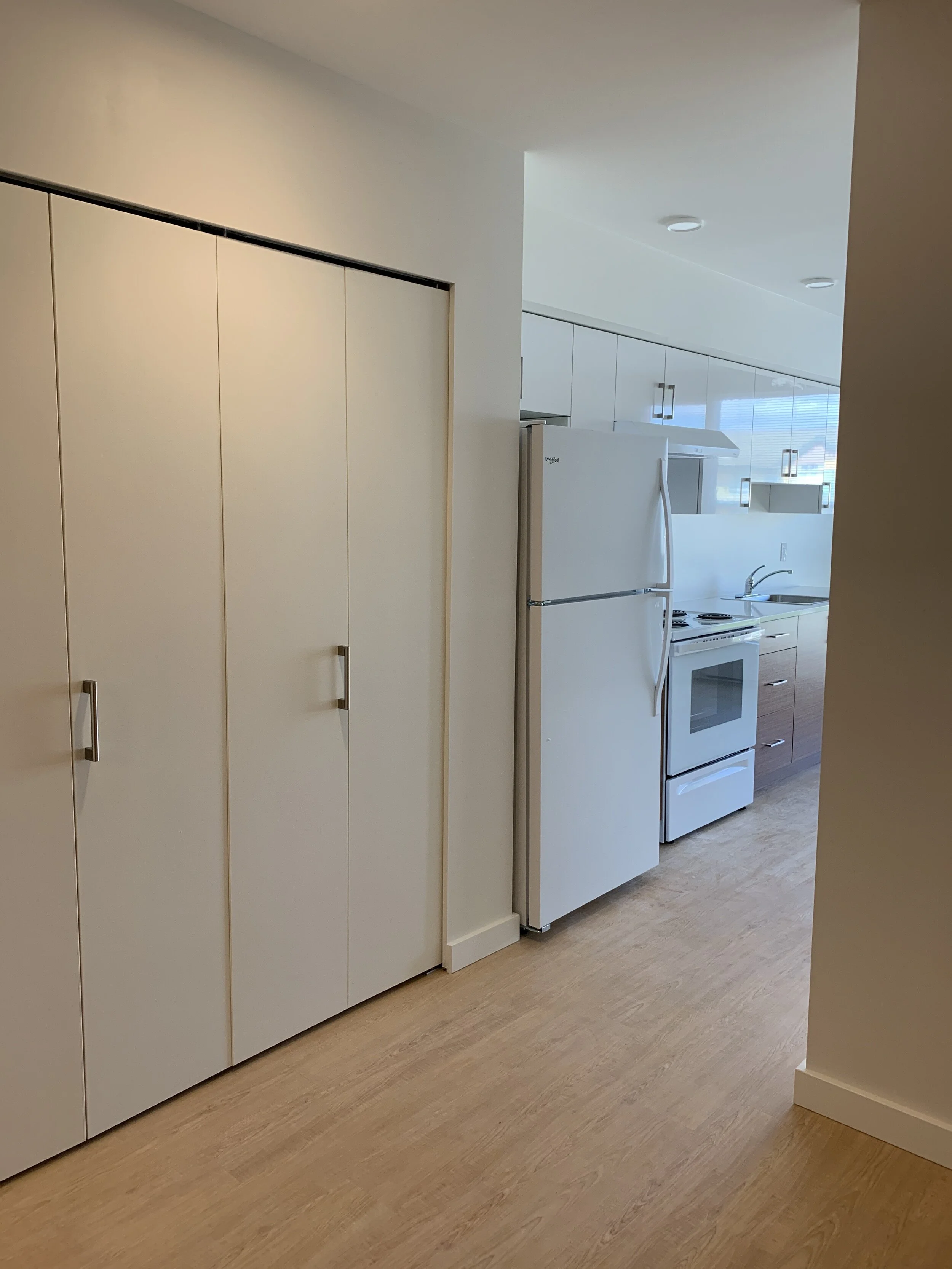 From separate bedroom area towards closet and galley kitchen.