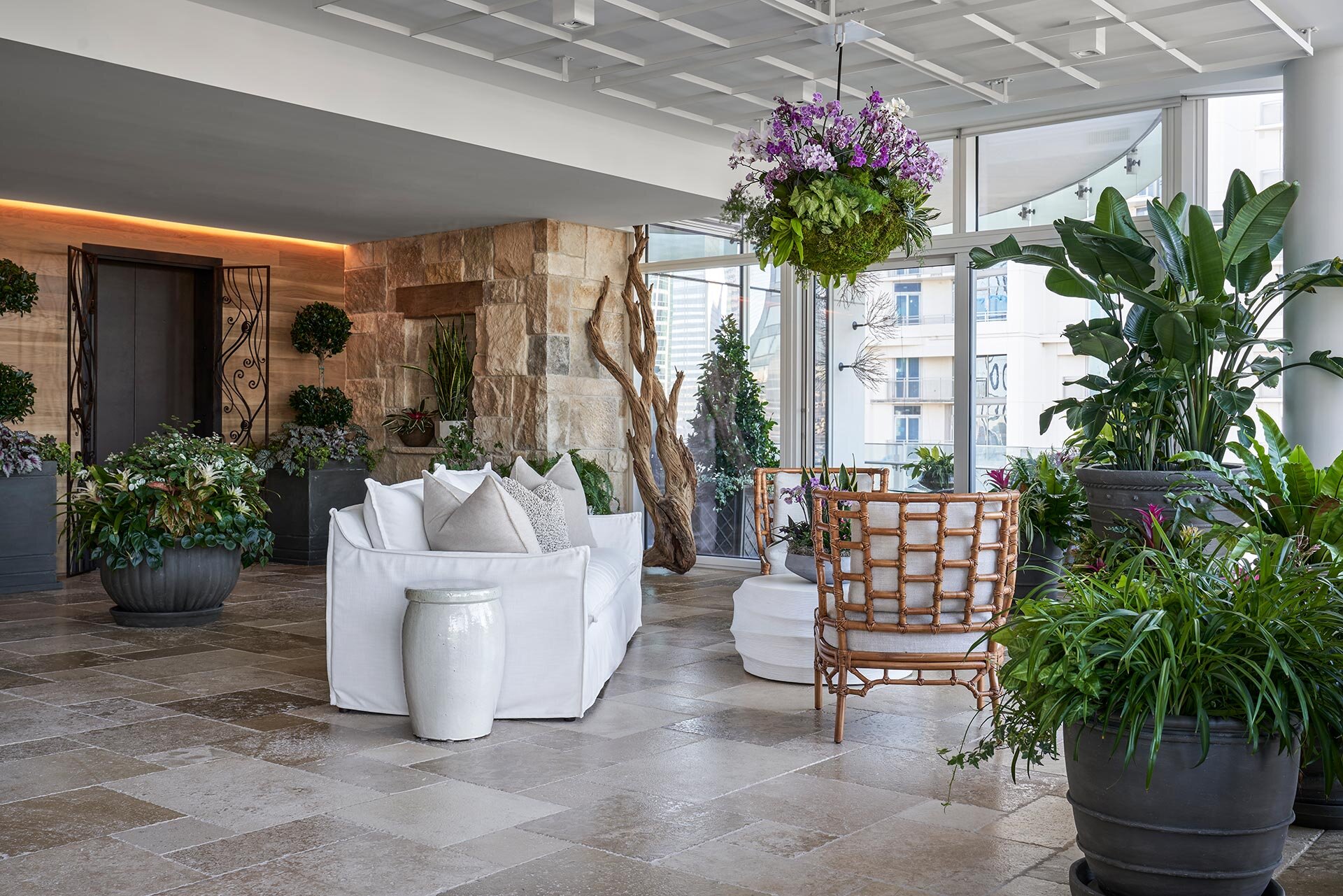  Modern comfortable contemporary in Museum Tower high-rise in downtown Dallas, Texas featuring custom metalwork gates, greenery and exterior materials create a garden atmosphere 