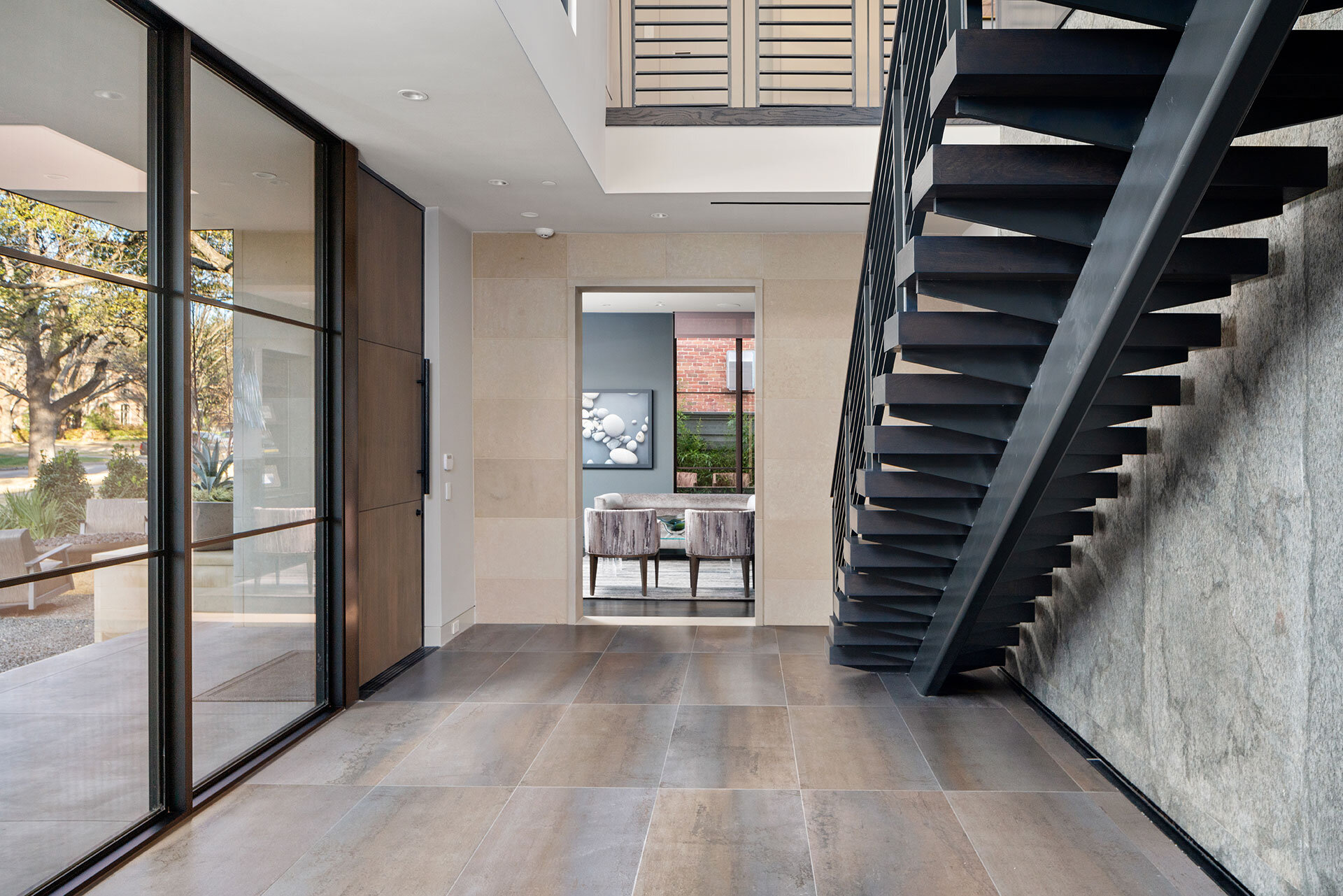  Urban contemporary home in University Park, Texas featuring dramatic foyer space with single stringer steel and wood stair 
