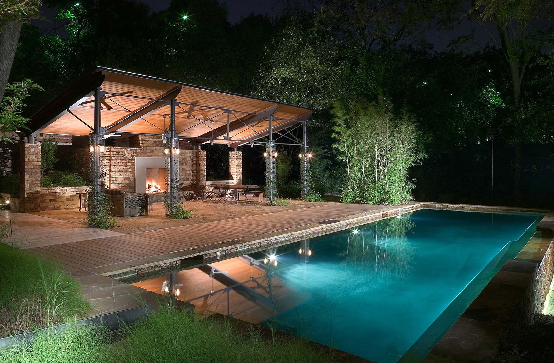  Modern comfortable contemporary home in Park Cities Dallas Texas featuring backyard oasis with a large pool and pavilion with fireplace 