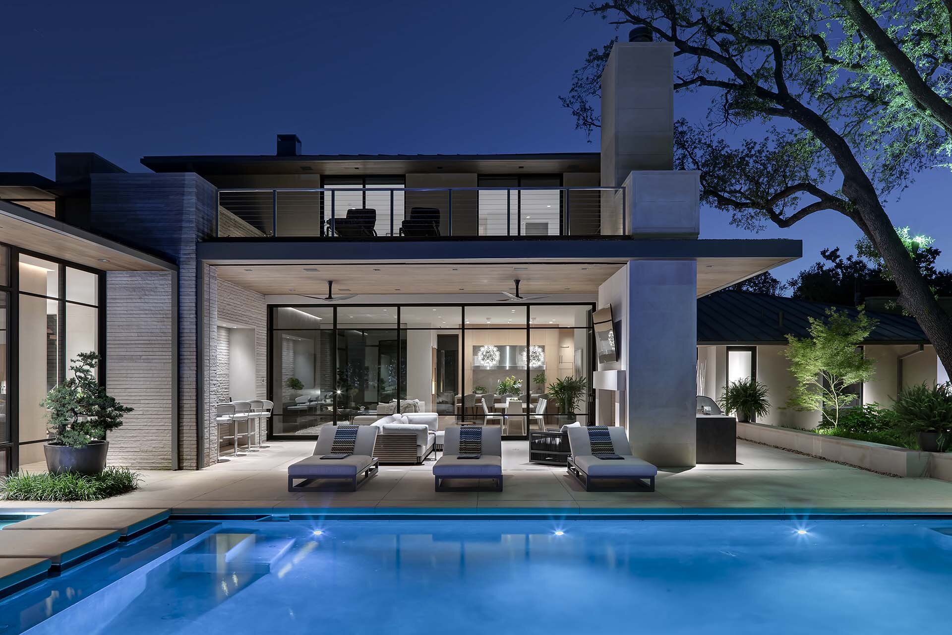  Modern comfortable contemporary home in Preston Hollow Dallas Texas featuring a fluid connection between interior and exterior with views of living area from pool terrace 