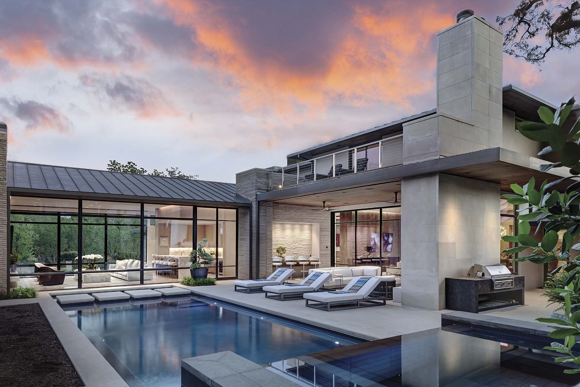 Modern comfortable contemporary home in Preston Hollow Dallas Texas featuring a fluid connection between interior and exterior with views from pool terrace 