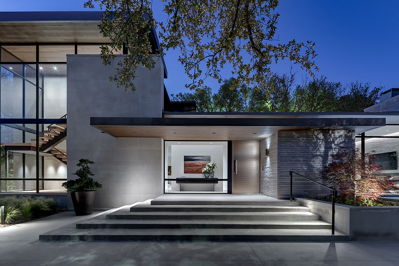  Modern comfortable contemporary home in Preston Hollow Dallas Texas featuring a modern front entry with stairwell at corner of home creating a sculptural element of steel, wood and glass 