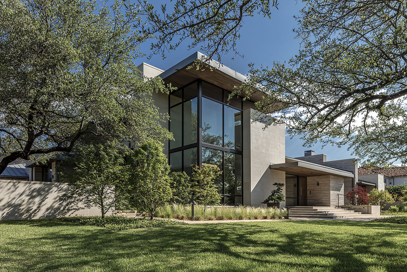  Modern comfortable contemporary home in Preston Hollow Dallas Texas featuring modern front exterior with stairwell at corner of home creating a sculptural element of steel, wood and glass 