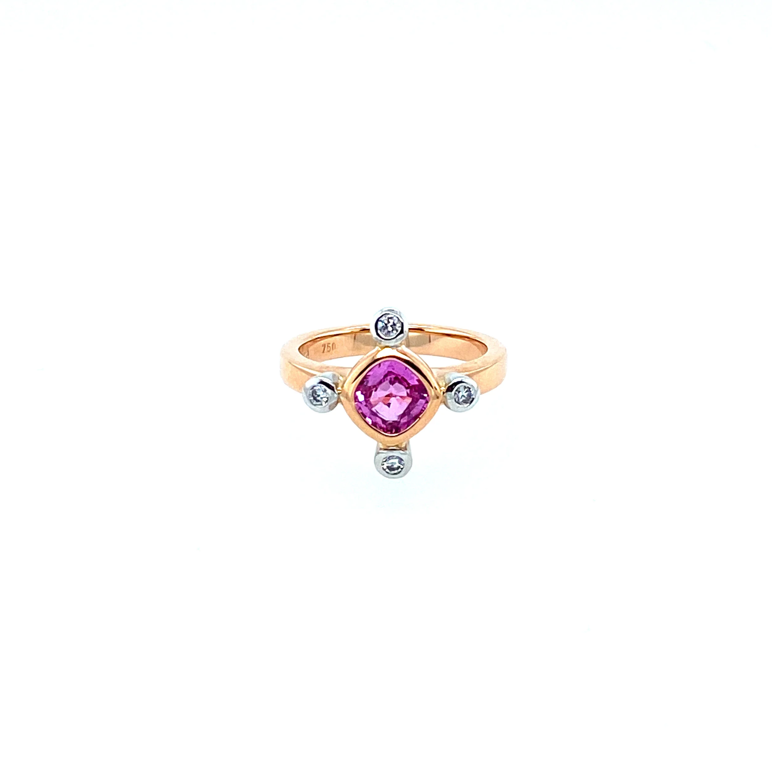 A 18ct rose & white gold dress ring featuring a luminous pink 1.10ct cushion cut sapphire and four 0.03ct E/VS diamonds.  (Currently Available)
