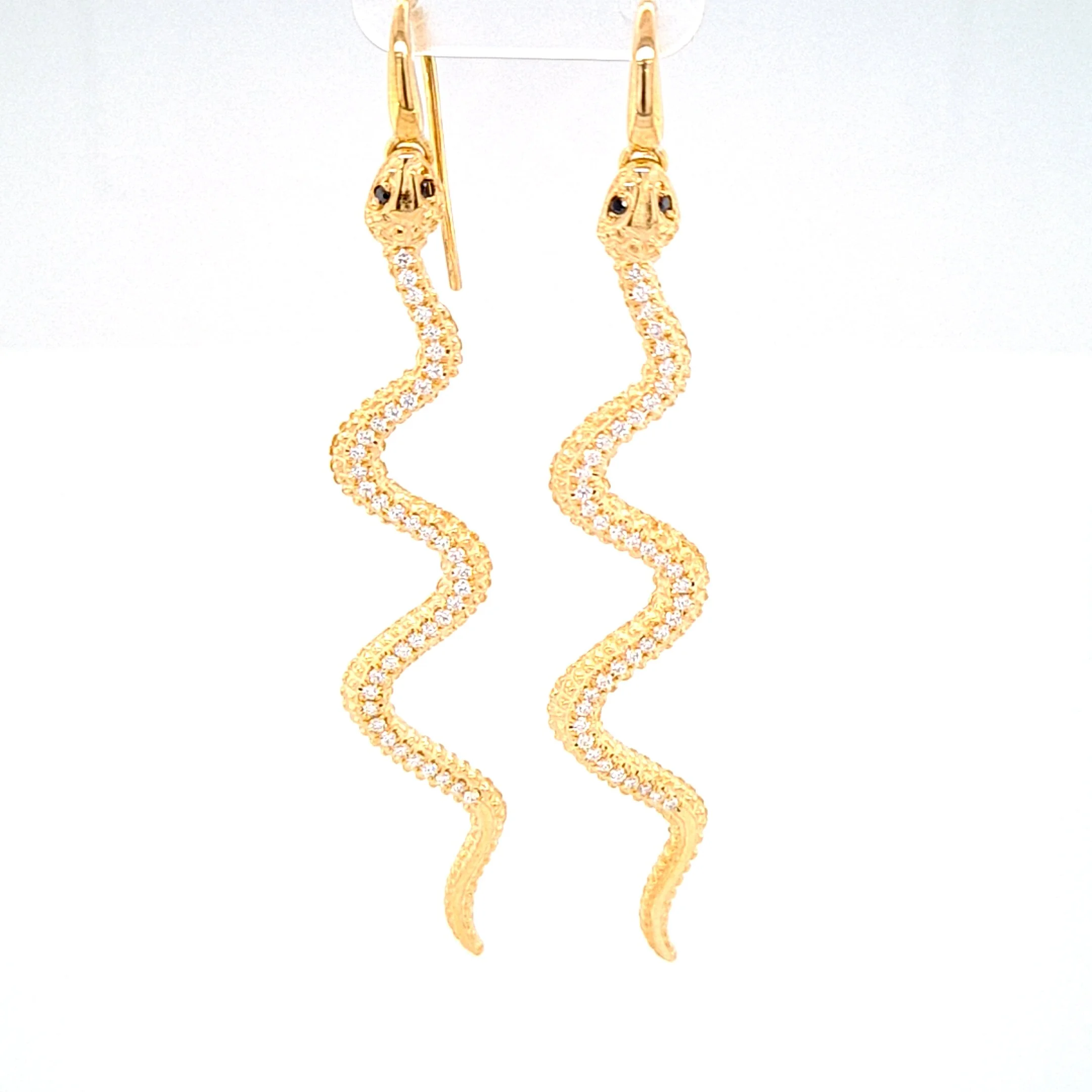 Yellow gold snake earrings with white diamond scales and black diamond eyes. 