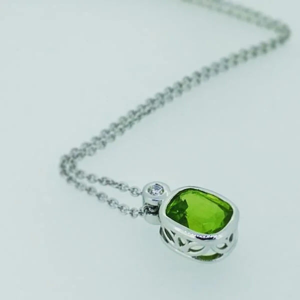 This silver pendent features a .10ct F/Vs diamond sitting atop a beautiful 3.88ct pistachio green peridot from Burma.  Peridot is the birthstone for August and this made a great birthday gift. 