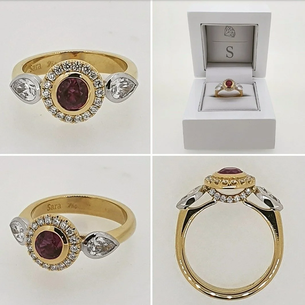 A modern take on a three stone ring featuring a stunning Burmese Ruby with diamond halo set in 18ct yellow and white gold. Either side of the center stone is two .30ct pear shaped F/Si diamonds.  This was a 40th (ruby) anniversary gift. 