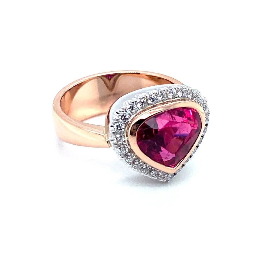 A real statement piece in this Rubellite stunner.  This Rubelite Tourmaline ring has a diamond halo and is set in 18ct rose gold and platinum.