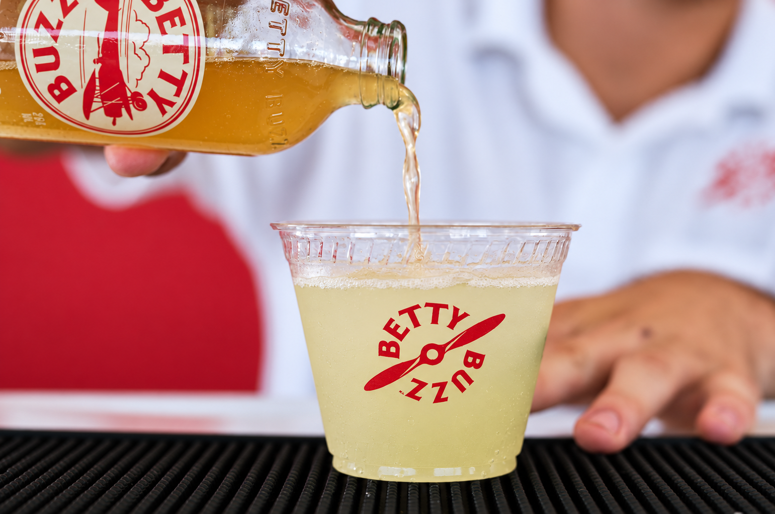 Betty Buzz bottle pour in soft light.png