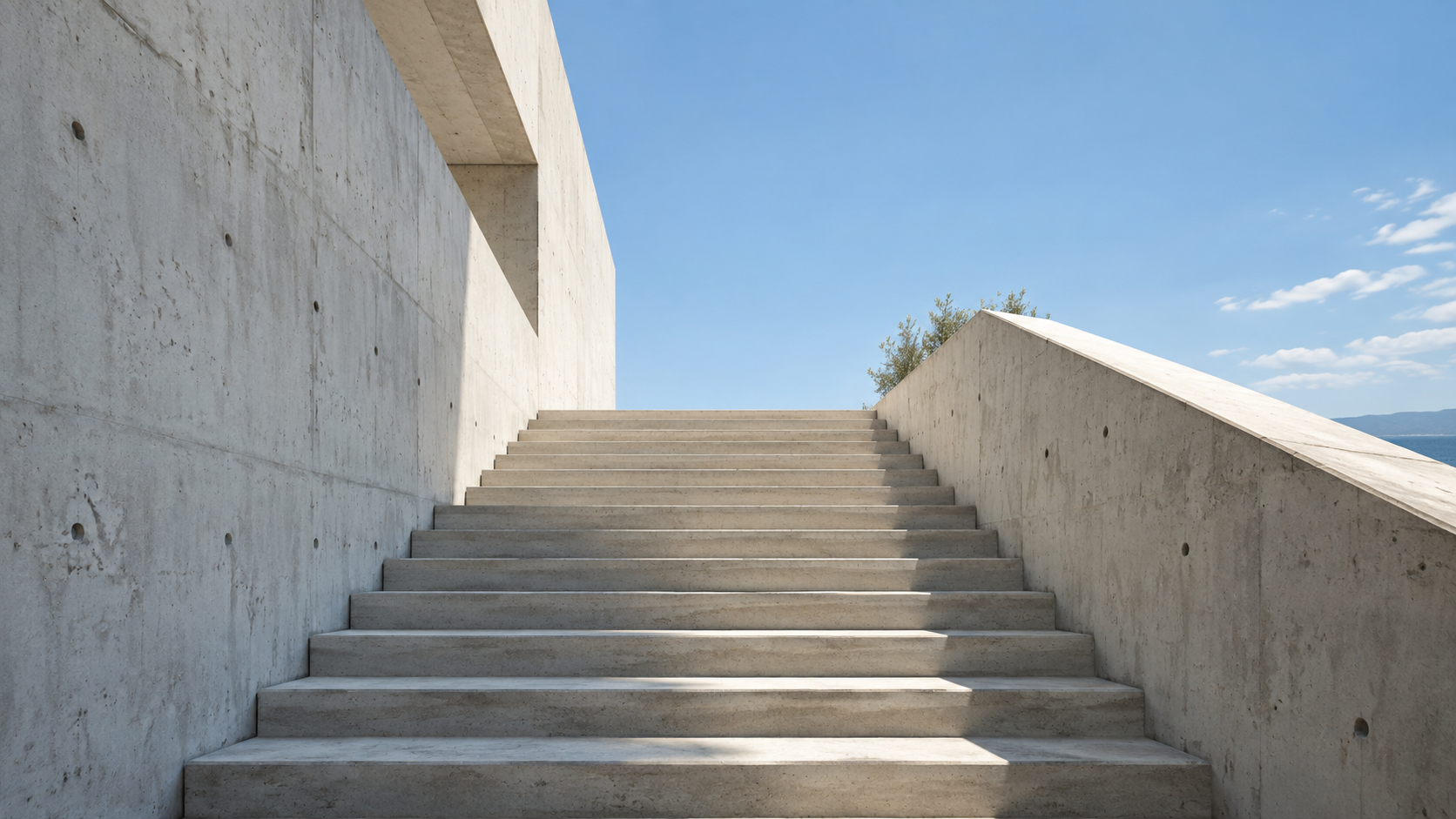 A sunlit concrete staircase rising toward open sky
