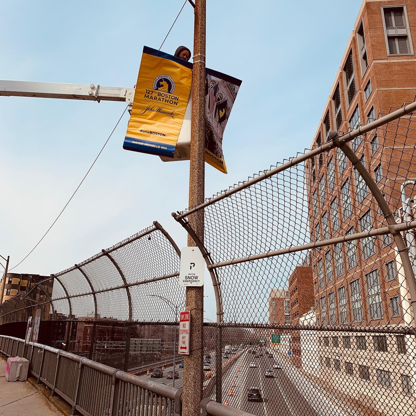 Hanging over the highway. Sometimes we have to install signs in precarious places, but we always get the job done with a smile. #hangintherekitty