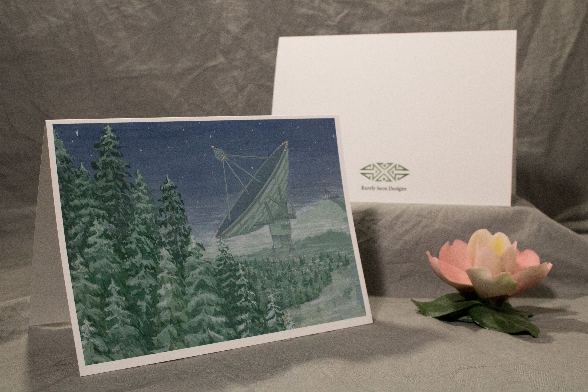 5x7 folded card depicting a large sci-fi style satellite in the distance