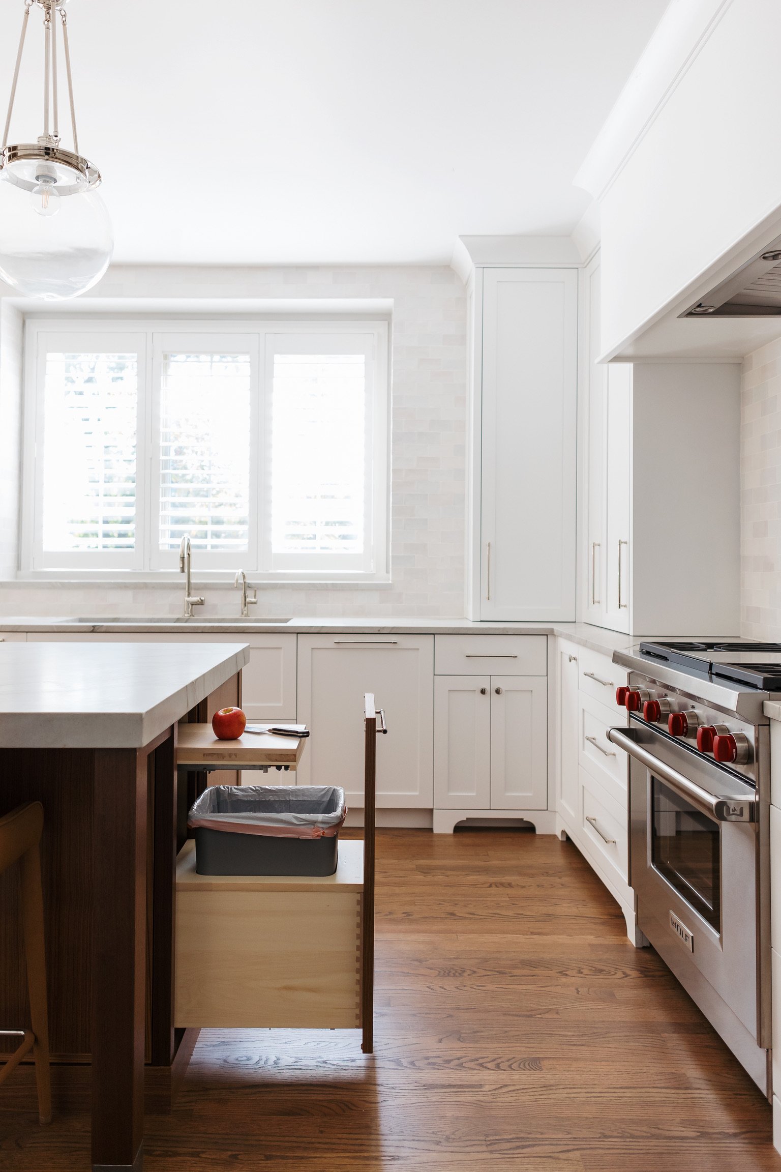 artesian-designs-kitchen-reno-chantilly-lace-walnut-island-tall-cabinet-built-in-cutting-board-over-garbage.jpg