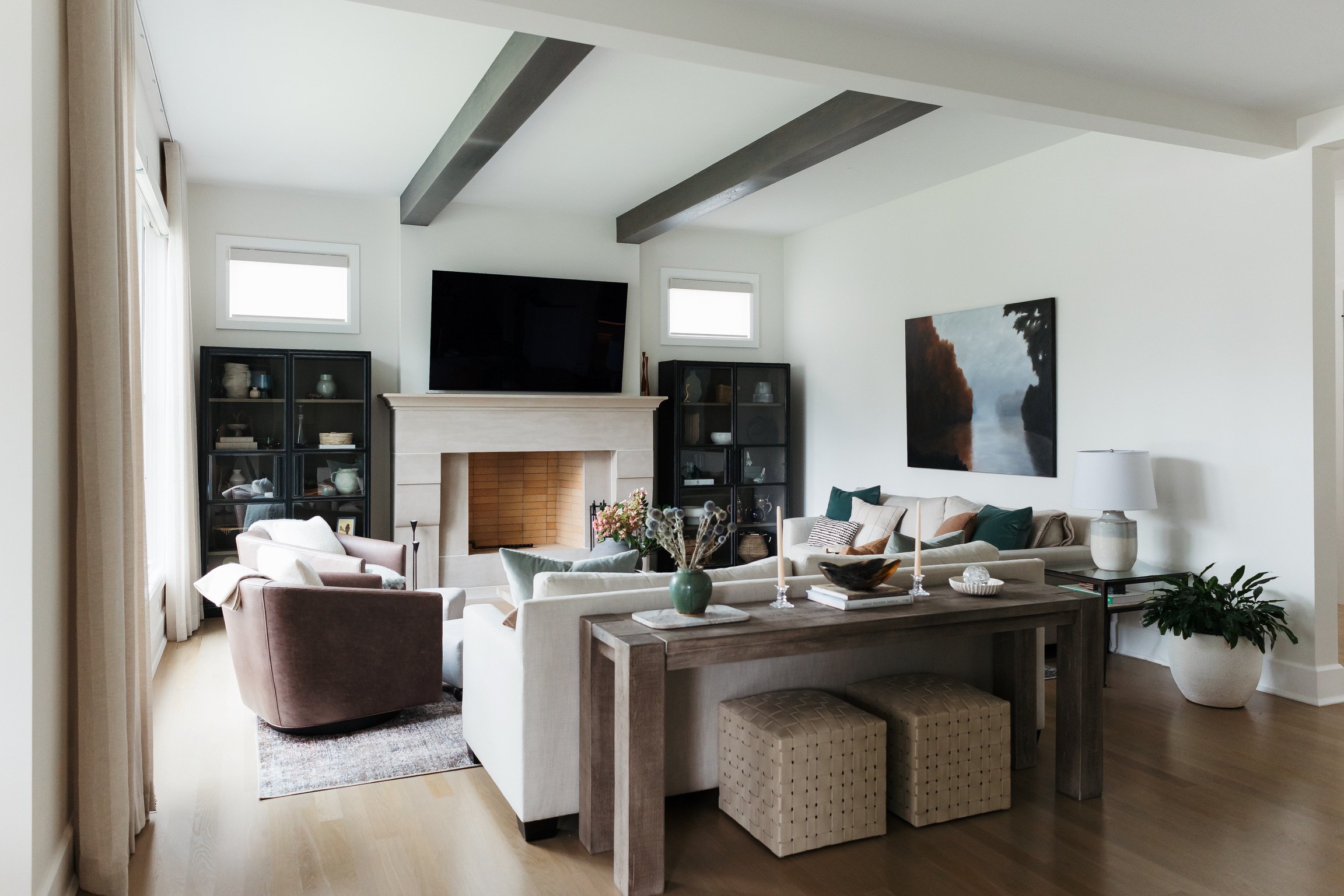 artesian-designs_family-room-limestone-fireplace-beams-console-table.jpg