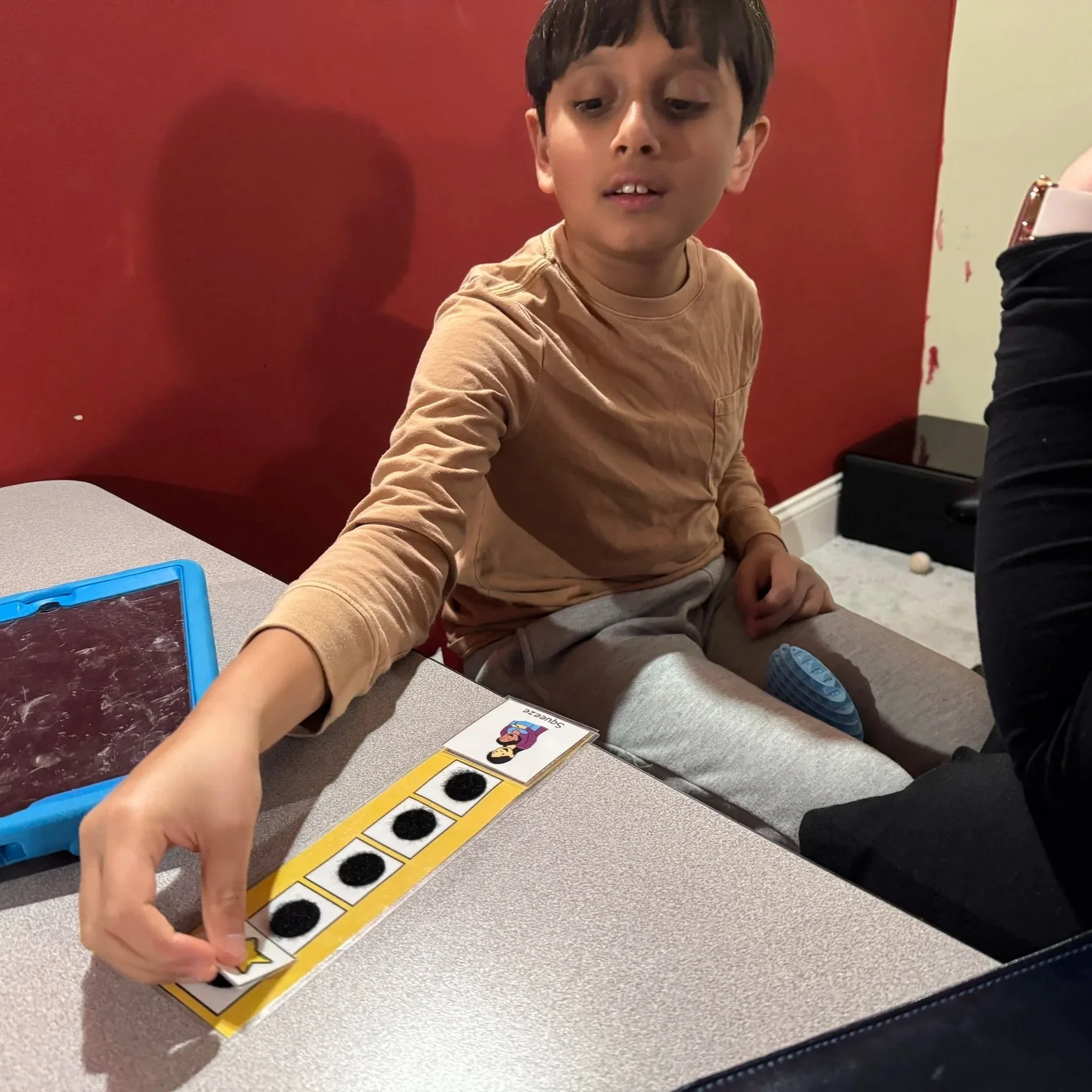Young male sitting with a tablet using a token system