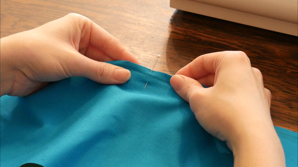 You can use a pin to mark the center front notches. Note how you can see the seam line we drew on for this seam.