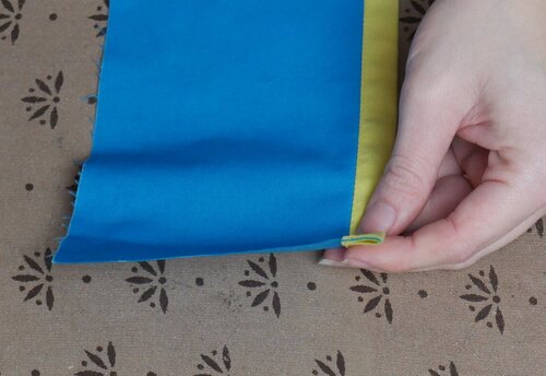 The binding encases the raw edges of the seam allowance.