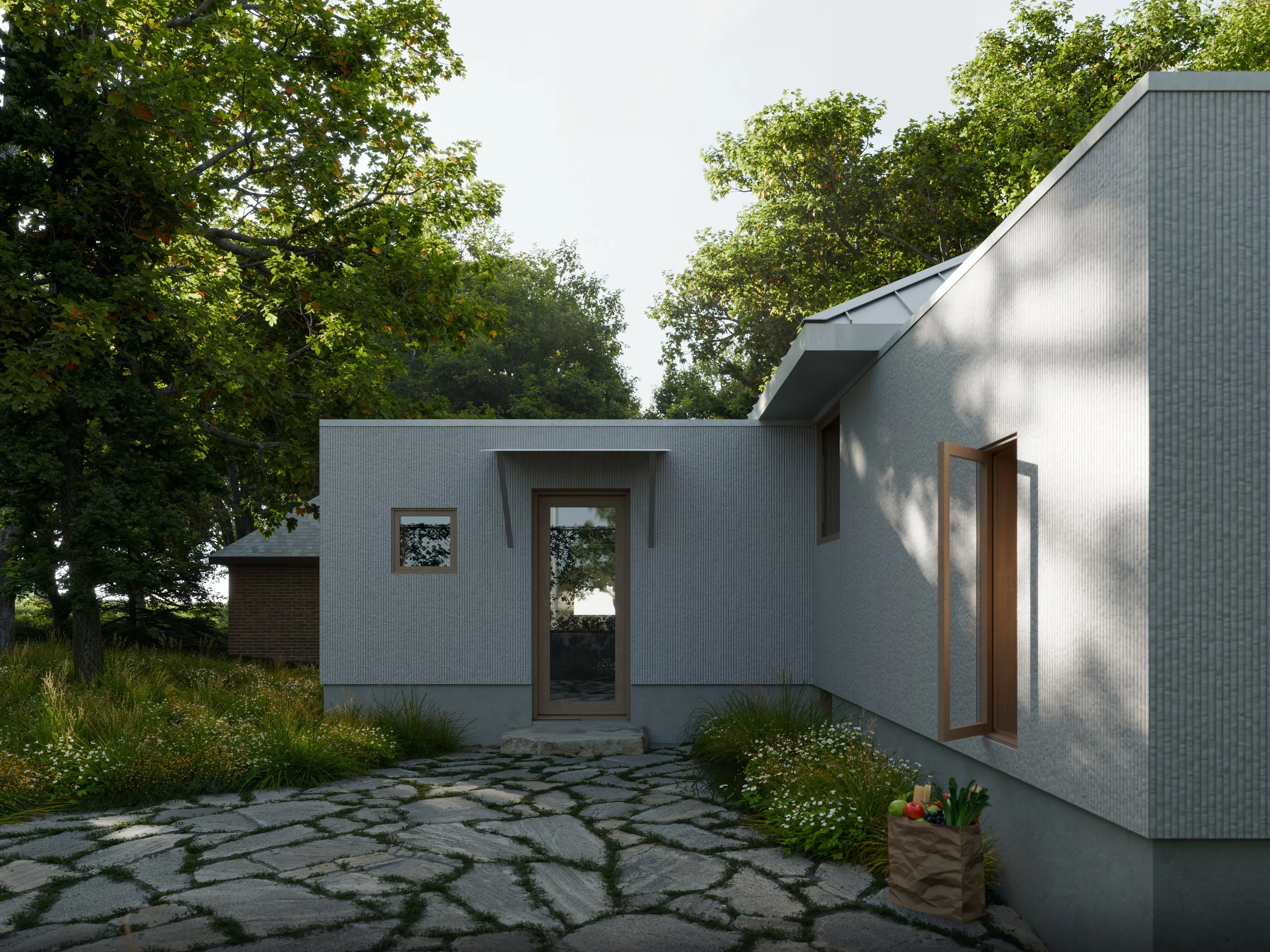 Modern house with textured exterior walls, large glass windows, and a flat roof, surrounded by green trees and a stone pathway, with a paper bag of fresh fruit on the ground.