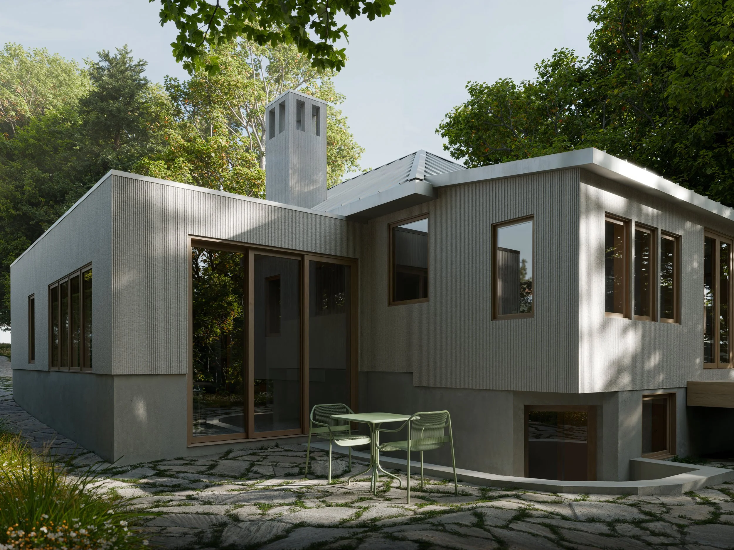 Exterior view of a modern house with a minimalist design, featuring large windows, a flat roof, and a white facade, surrounded by lush green trees and a stone patio with outdoor seating.