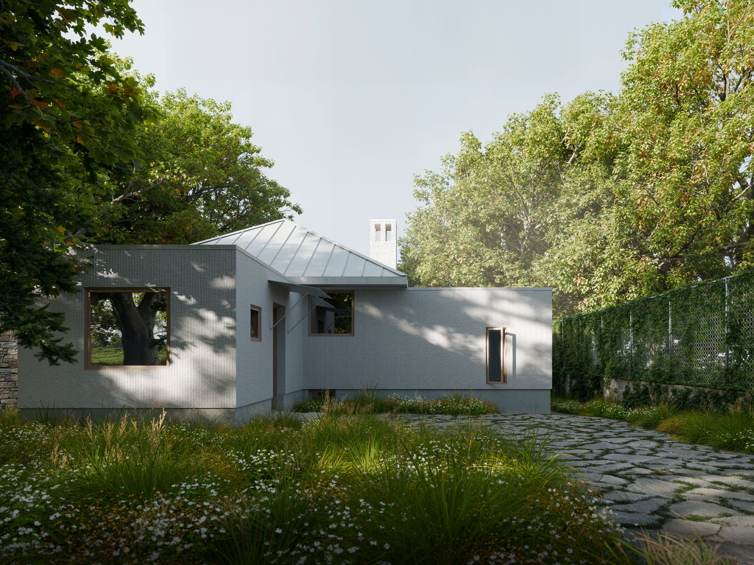 Modern house with metal roof, surrounded by trees and greenery, with a stone pathway in the garden.