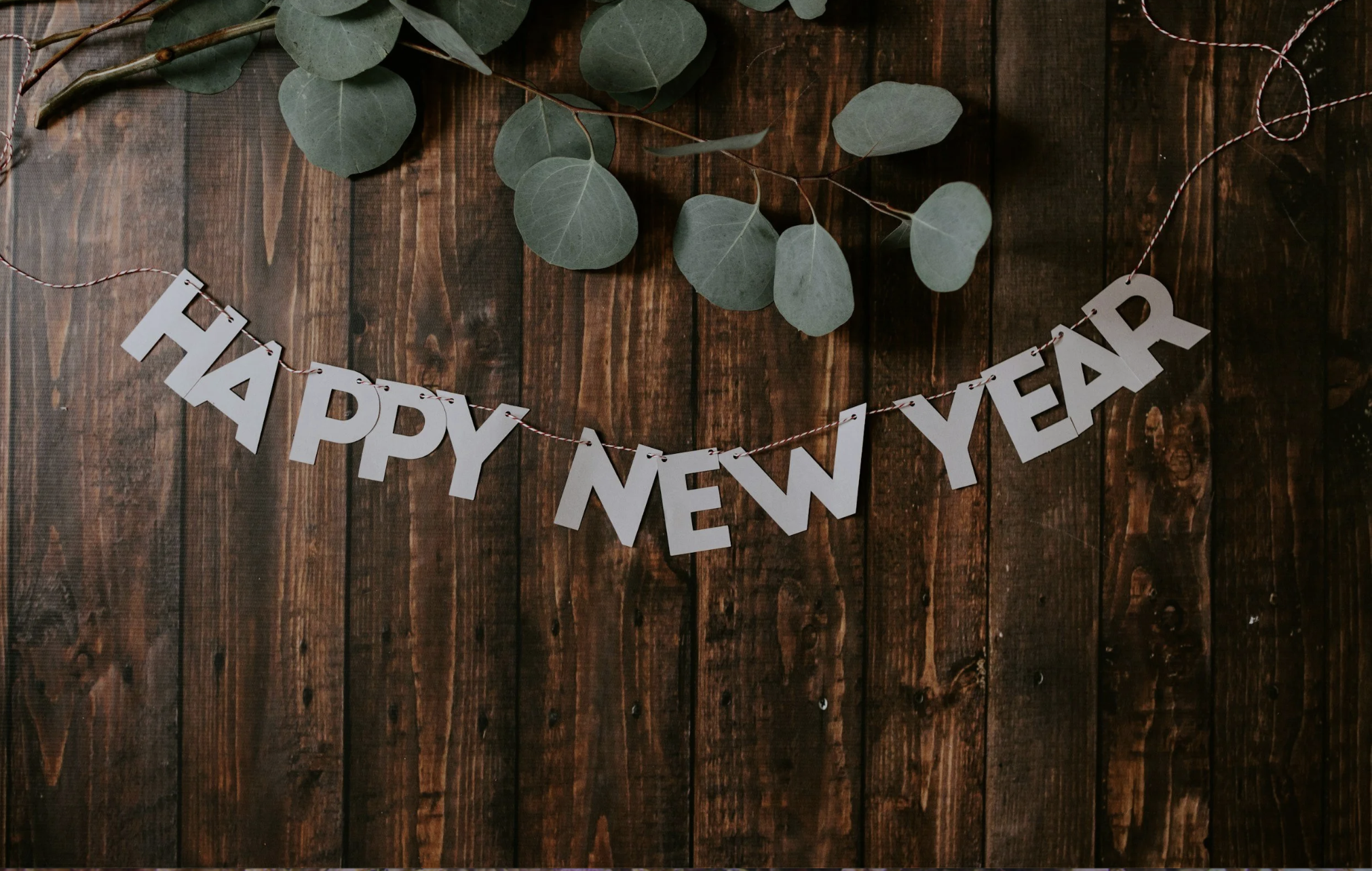 Happy New Year banner representing New Year's celebrations and planning holiday travel in advance.