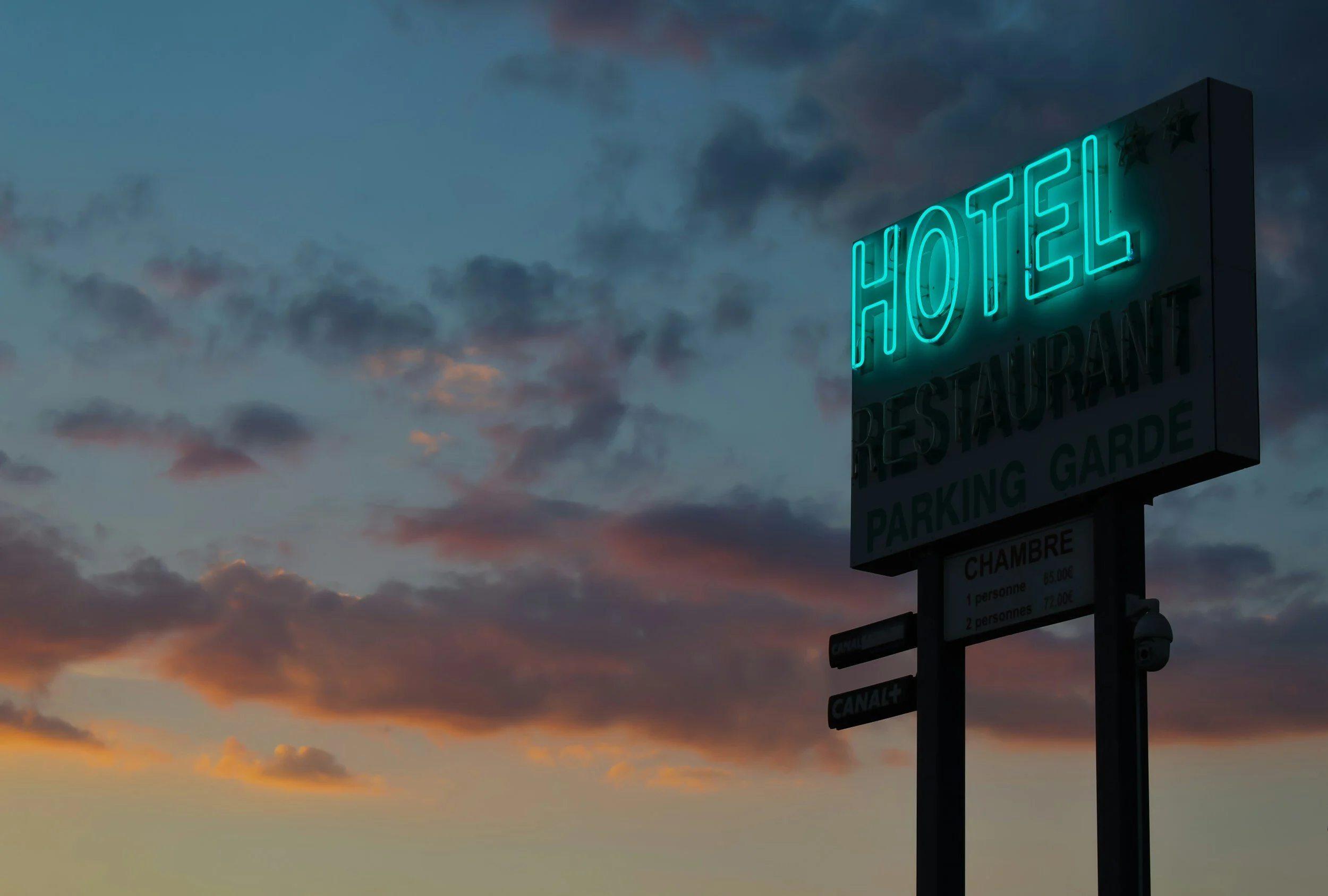 Hotel entrance sign representing personalized hotel accommodations and lodging reservations through professional travel planning services.