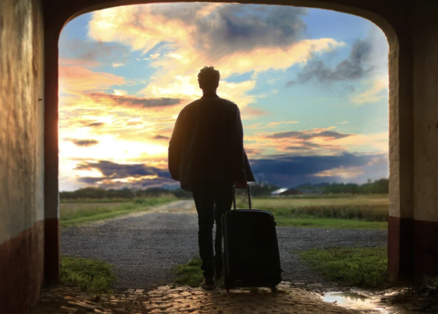 Traveler with rolling luggage beginning a journey, representing personalized travel planning and custom itineraries.