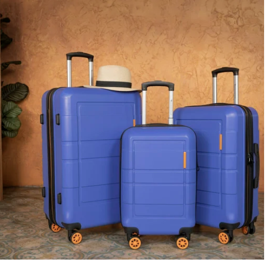 Three blue suitcases ready for travel, representing personalized vacation and business travel planning services.