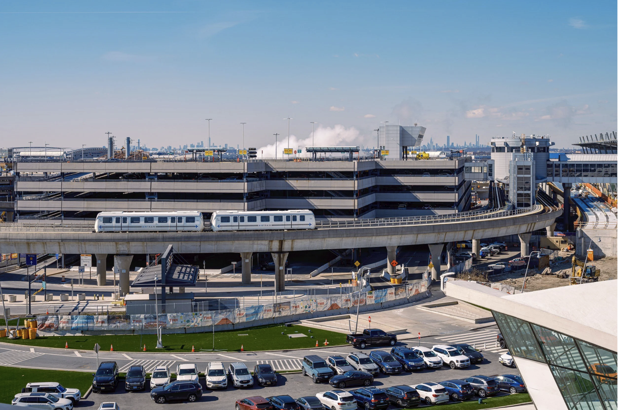 Airport parking lot with an airport tram, representing the importance of planning airport parking before traveling.