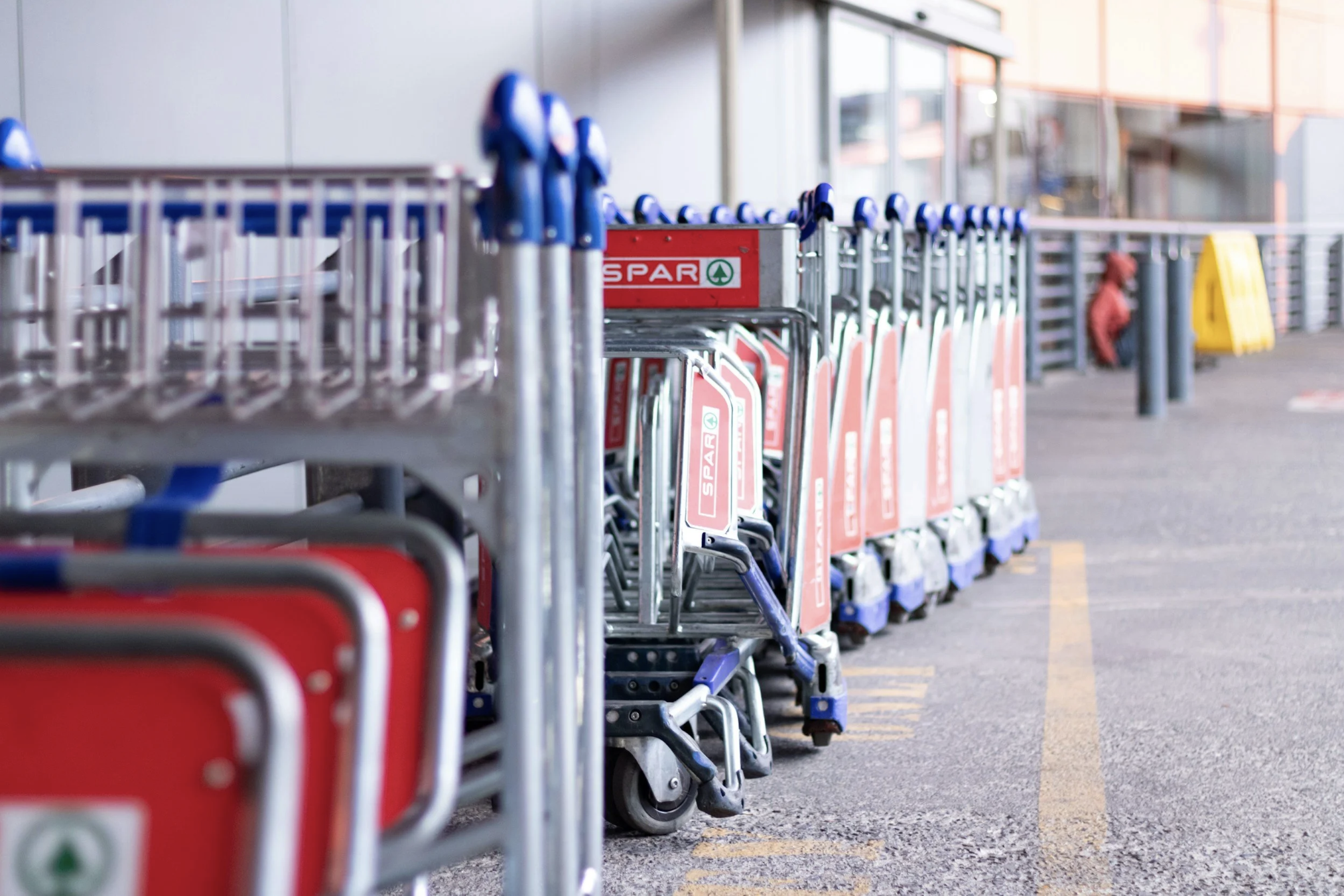 Stacked airport luggage carts at an airport, symbolizing organized travel planning and trip preparation.