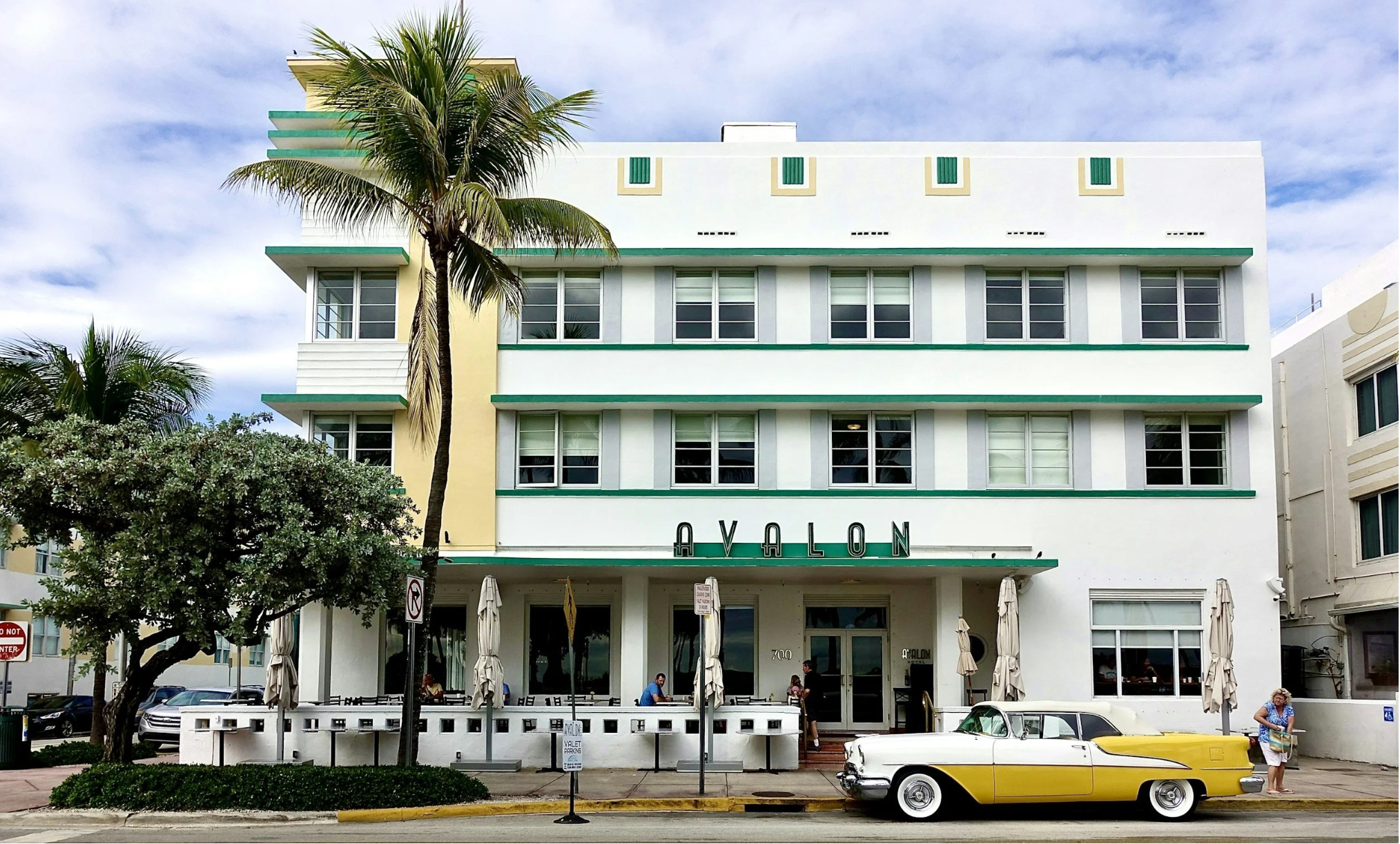 Art Deco architecture, palm trees, and a vintage car along Ocean Drive in South Beach, Miami, a popular warm-weather winter getaway.