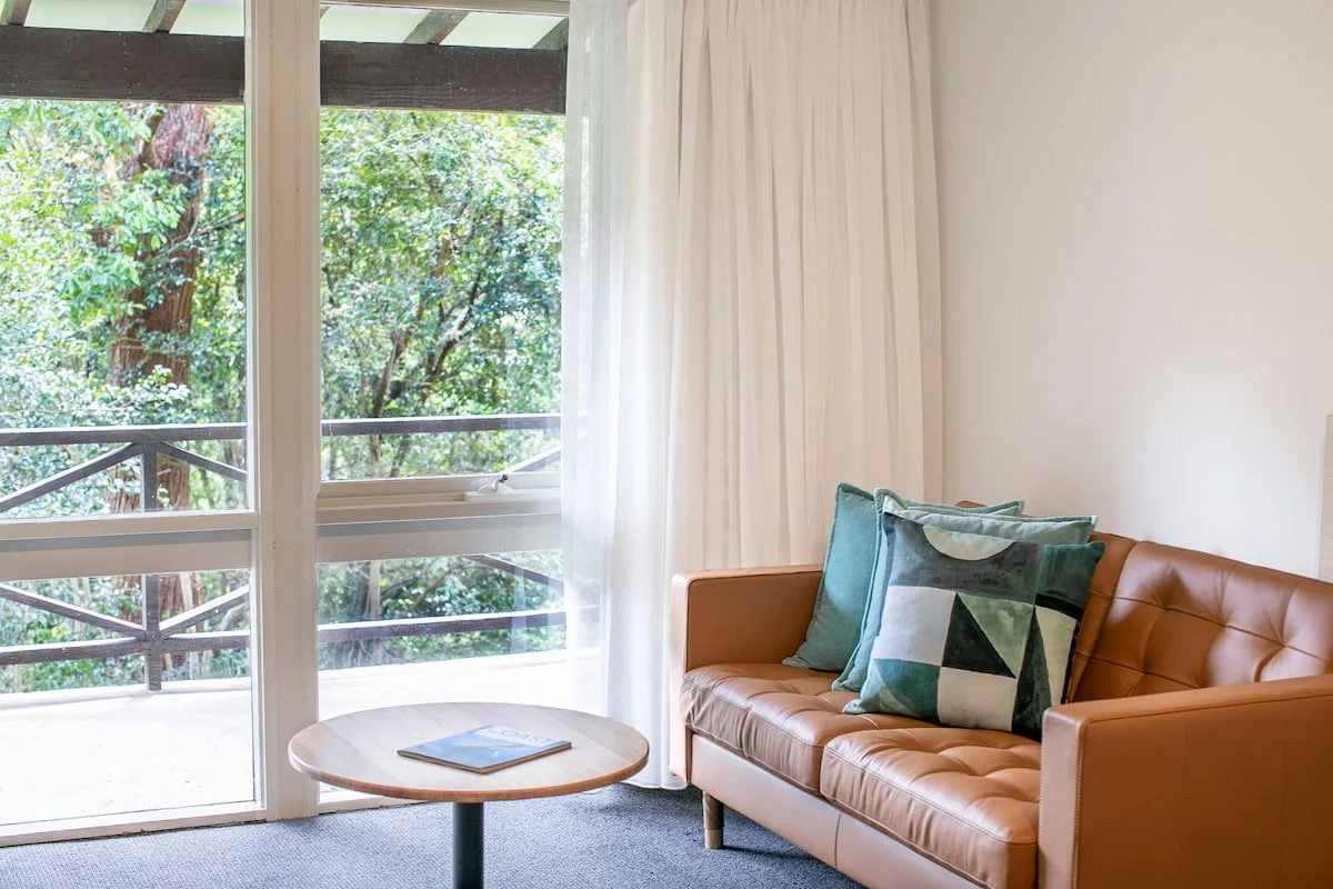 Rooms have a balcony with a leafy view